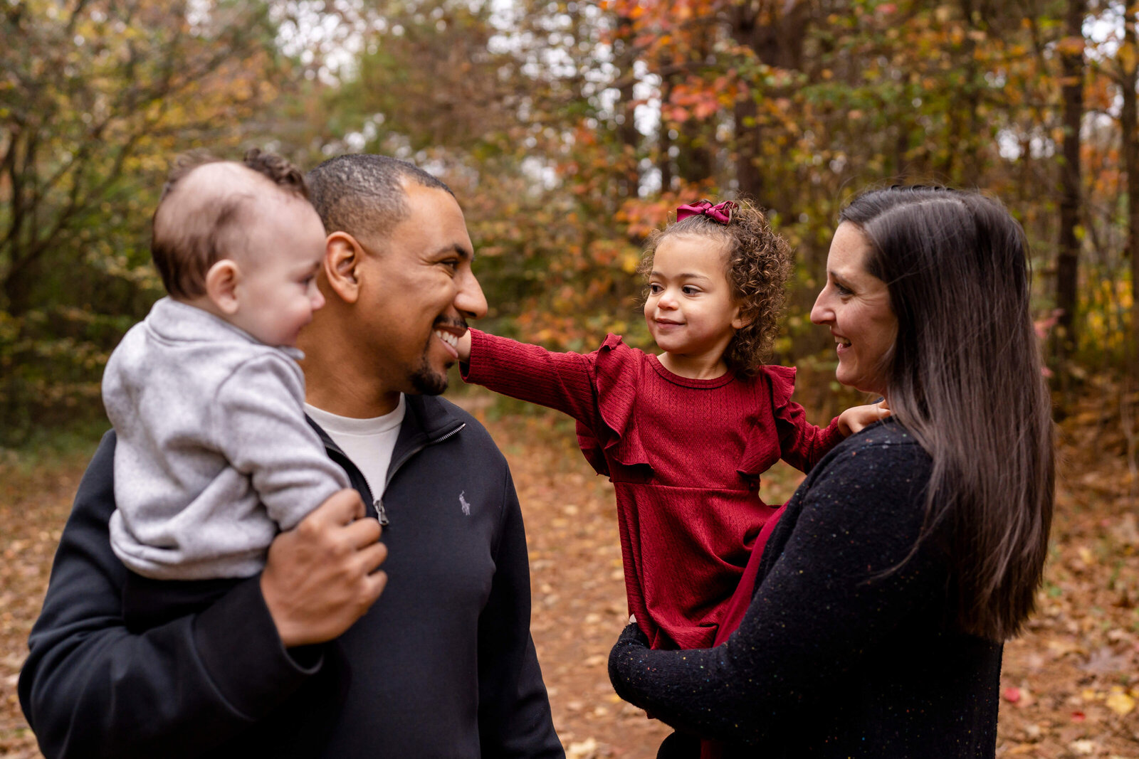 Atlanta Family Photographer, Parents and two kids outside in fall foliage