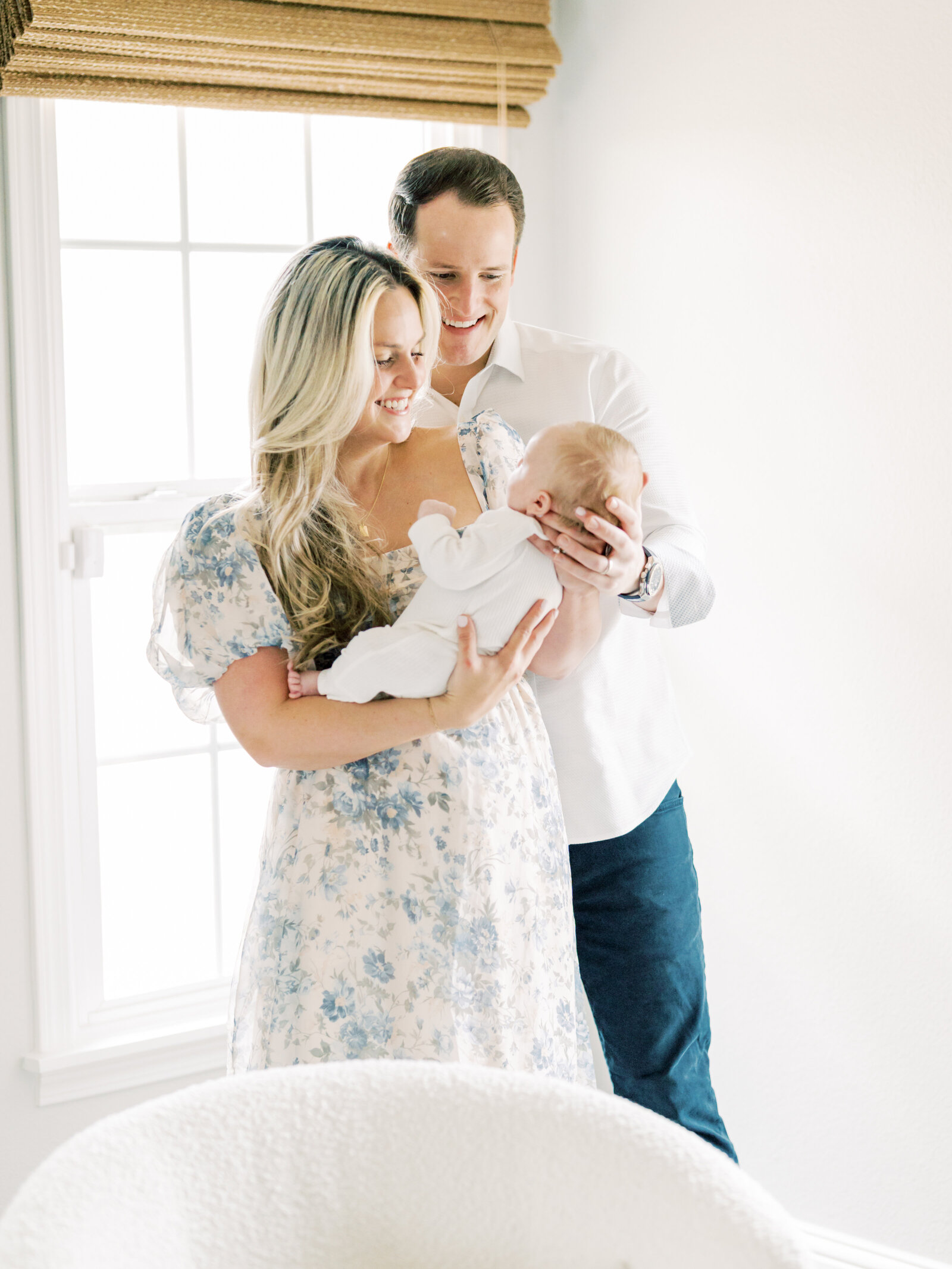 in home newborn session with mom and dad holding baby