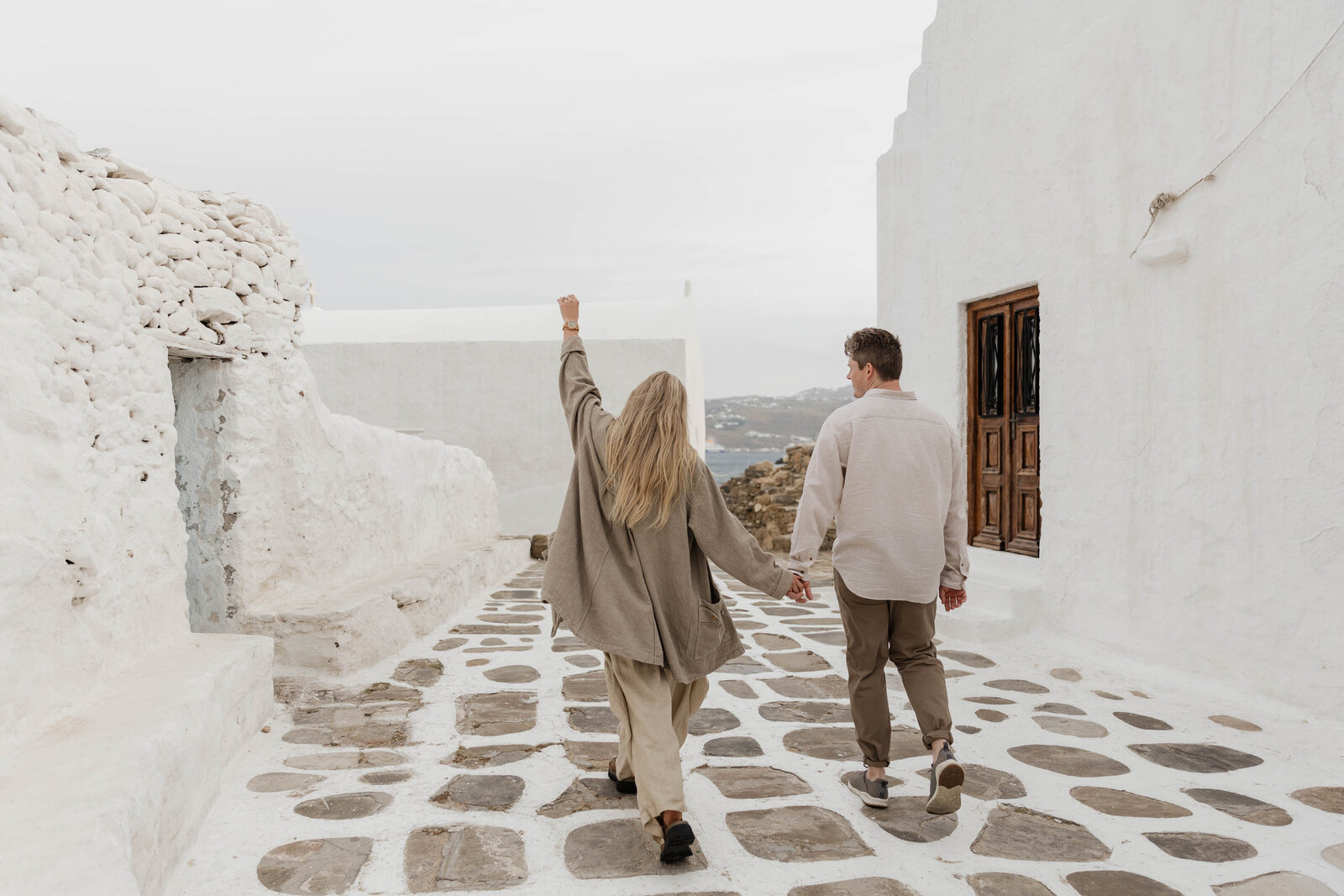 A couple running and laughing during their elopement,