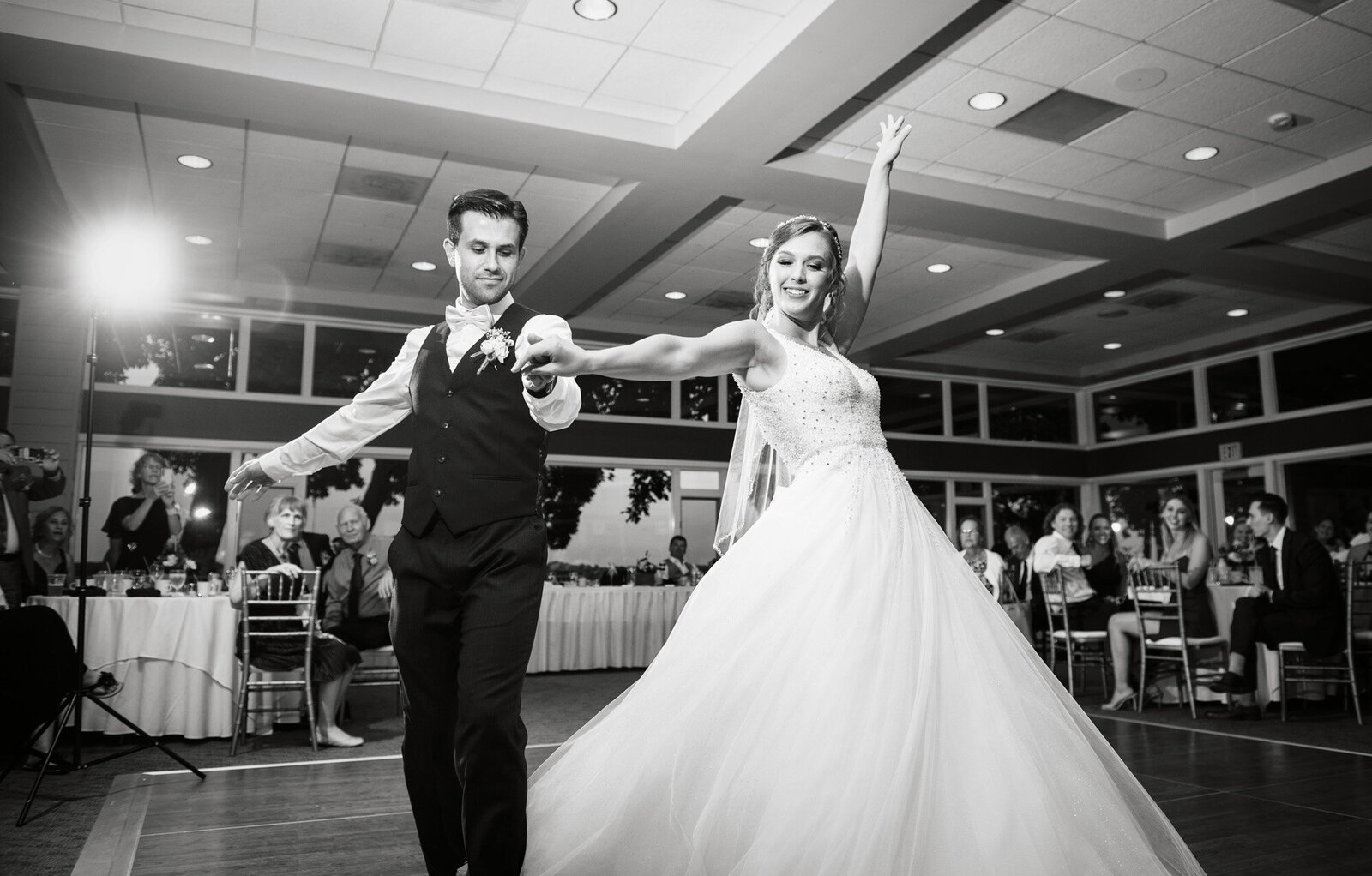 black and white photo of bride and groom during choreographed dance