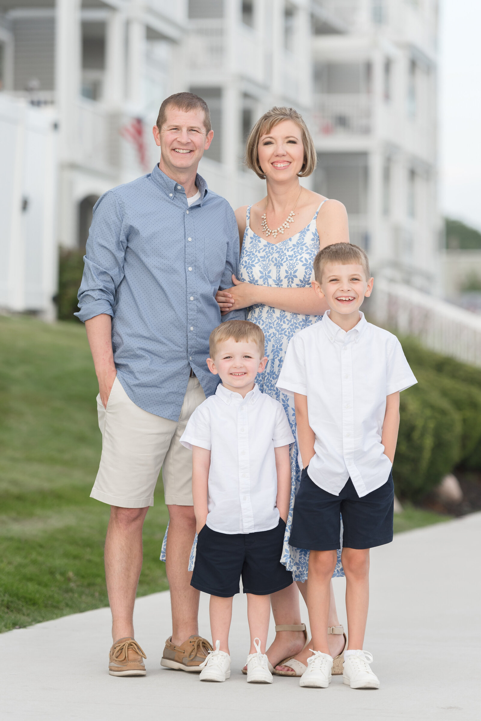 family of 4 standing on walk way at the yacht club in Ludington, Michigan