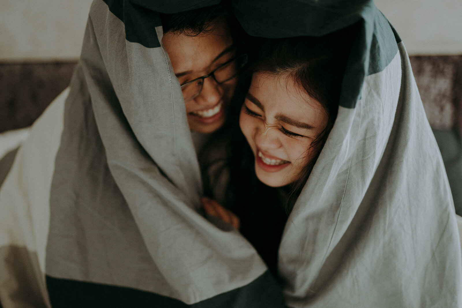 couple hide inside the blanket