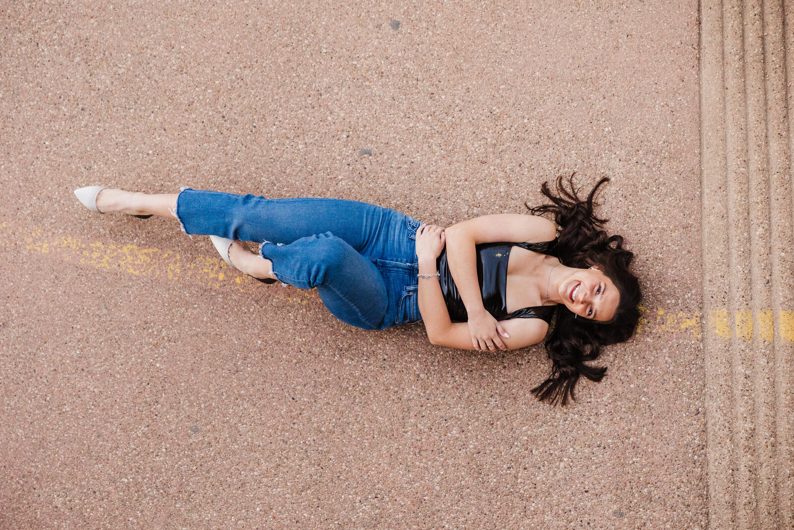 high-school-senior-lays-on-street