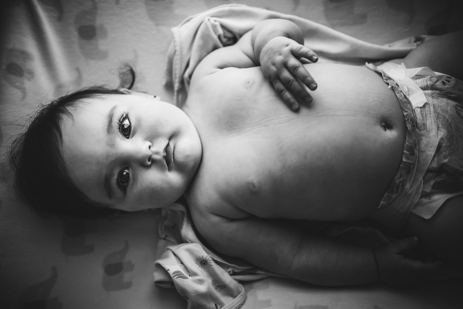black & white image of baby on changing table