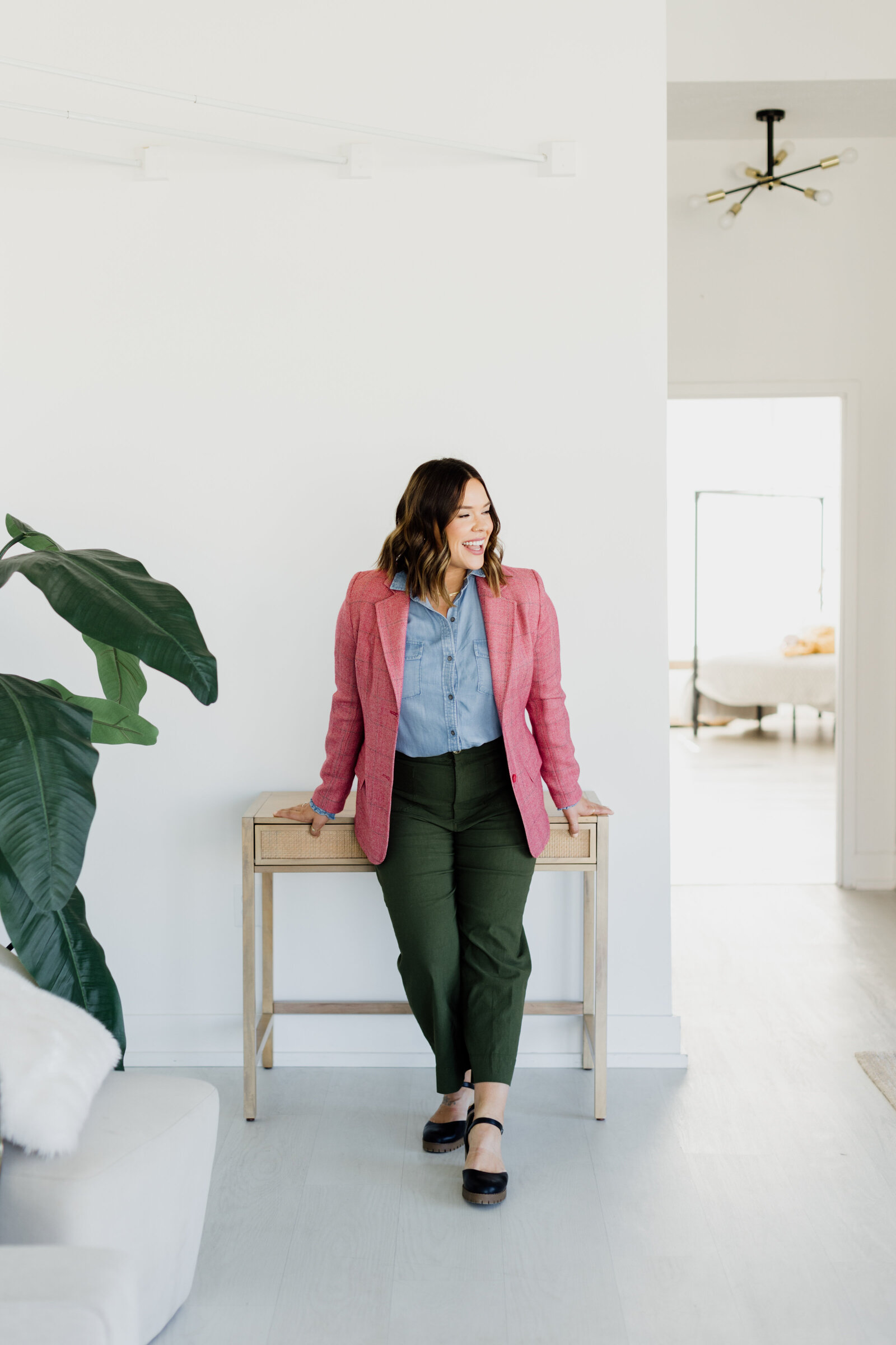 woman standing by desk in natural light studio lincoln nebraska