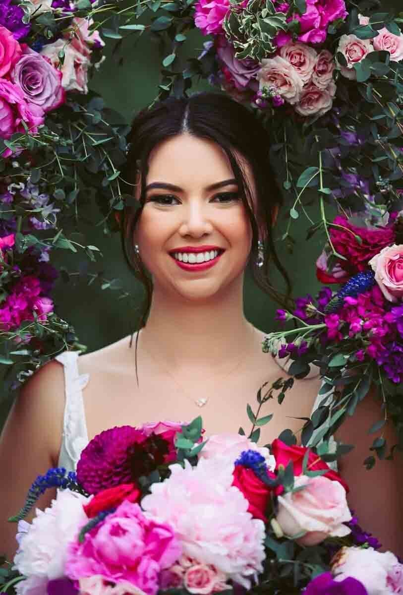 colorful bridal portrait surrounded by floral arrangements
