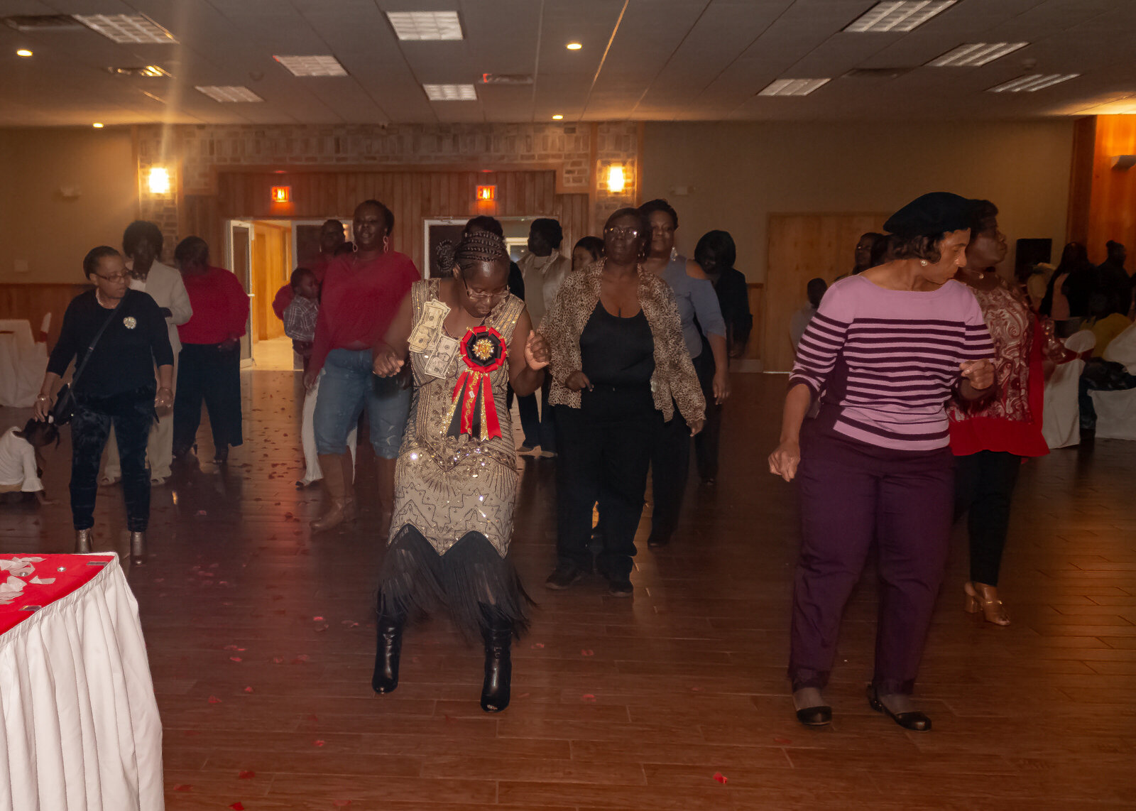 group of people dance on the dance floor during a party