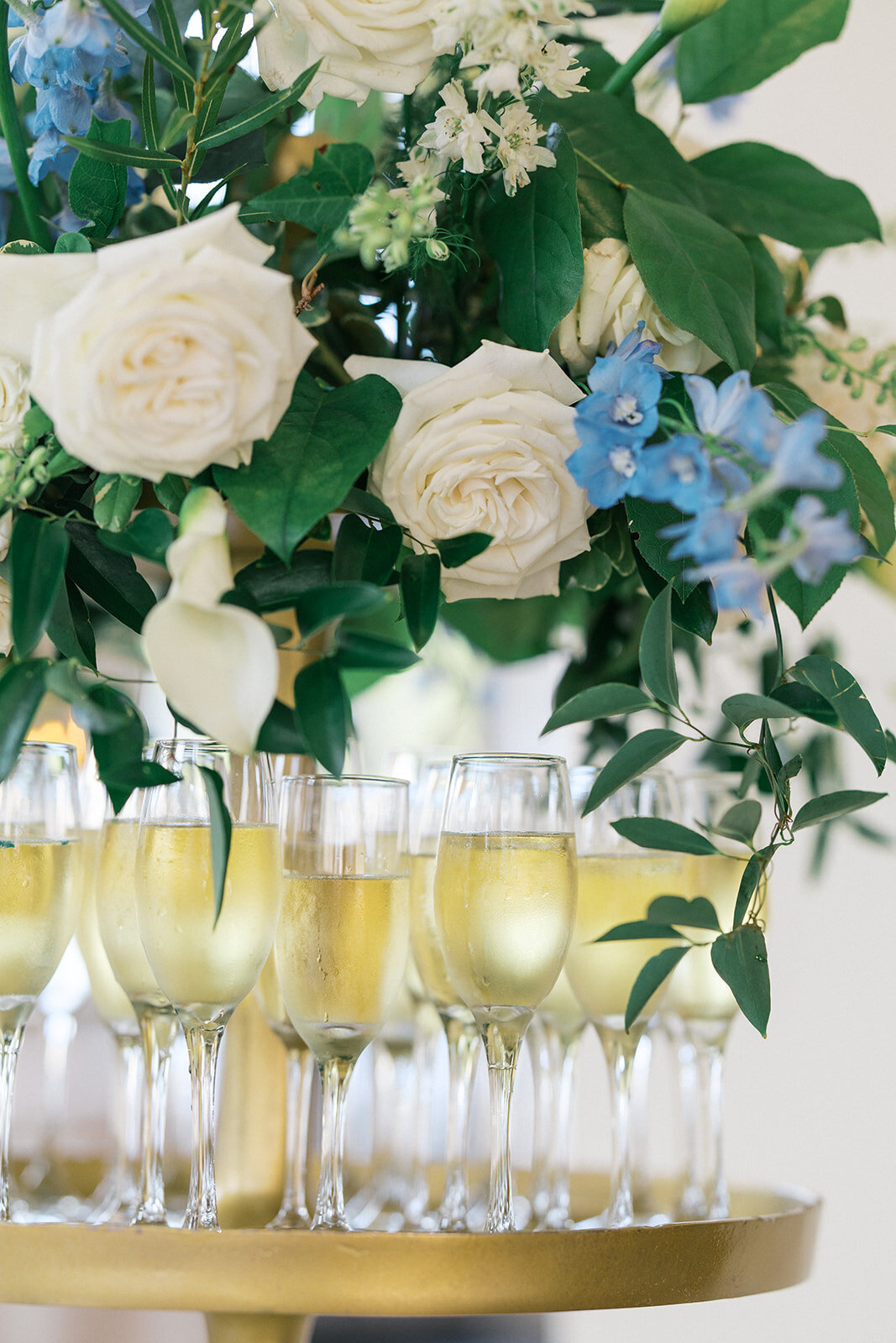 champagne chills under floral arrangement