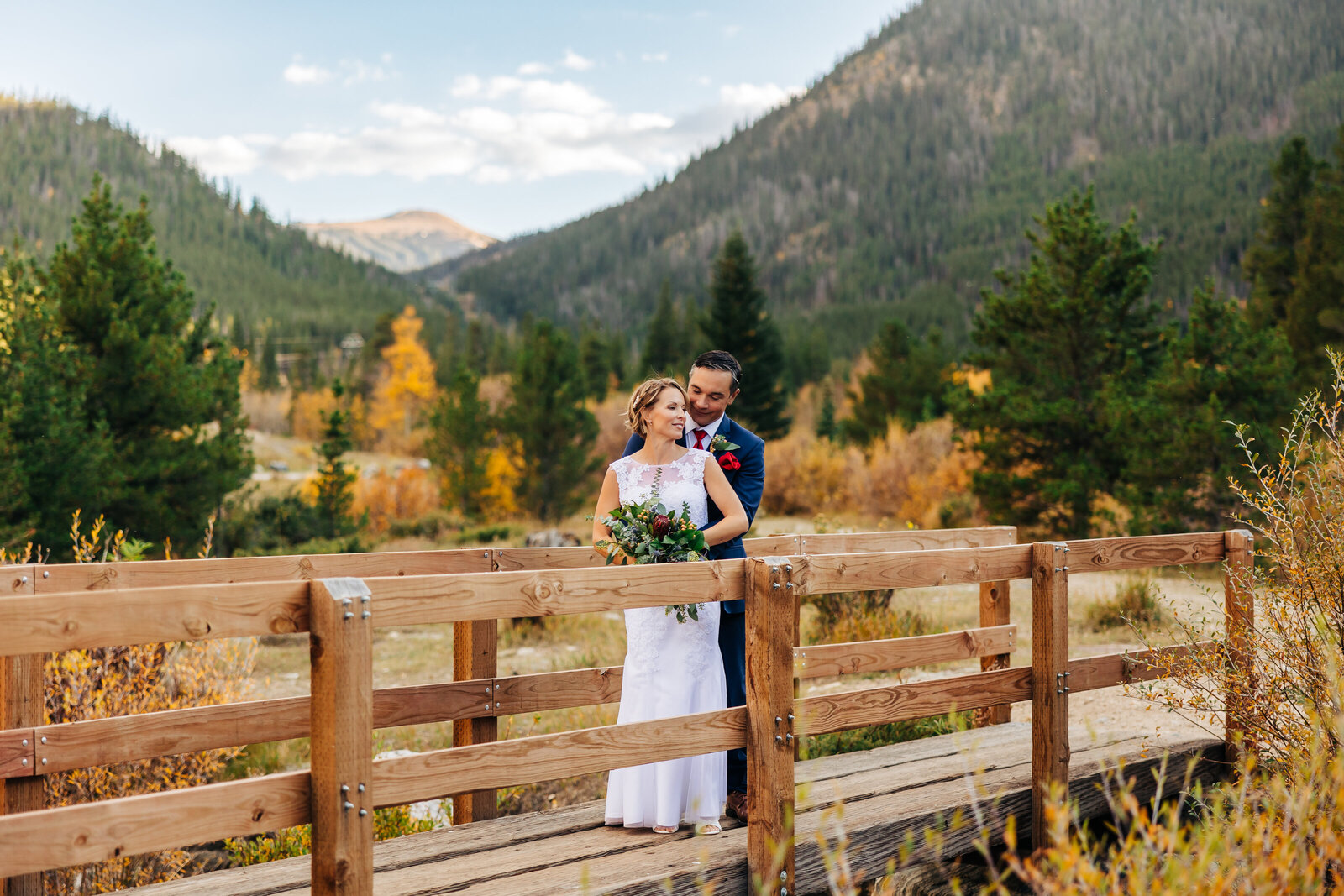 Boulder Wedding Photographer captures groom hugging bride from behind