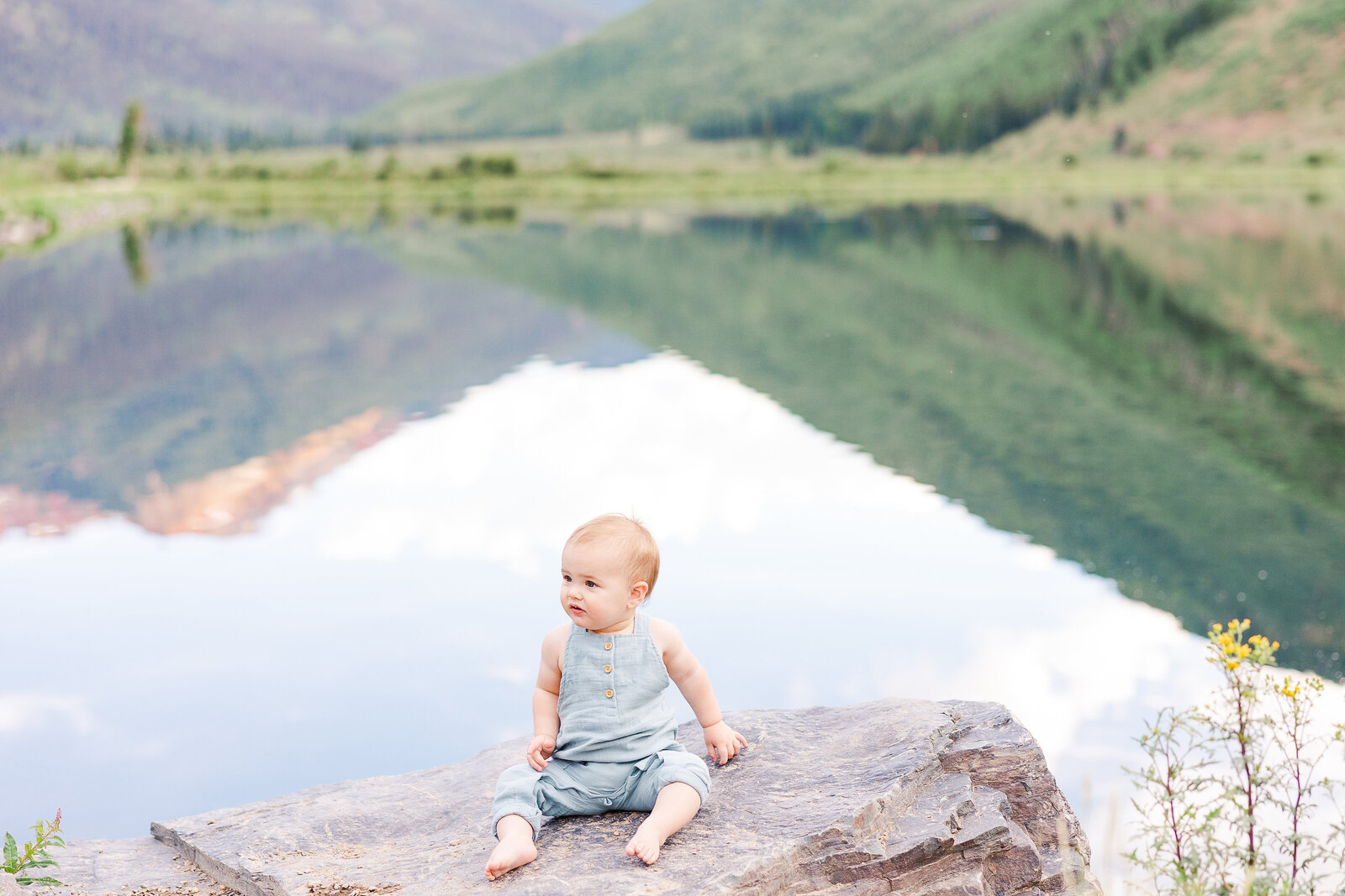 One year old little boy in front of crystal lake