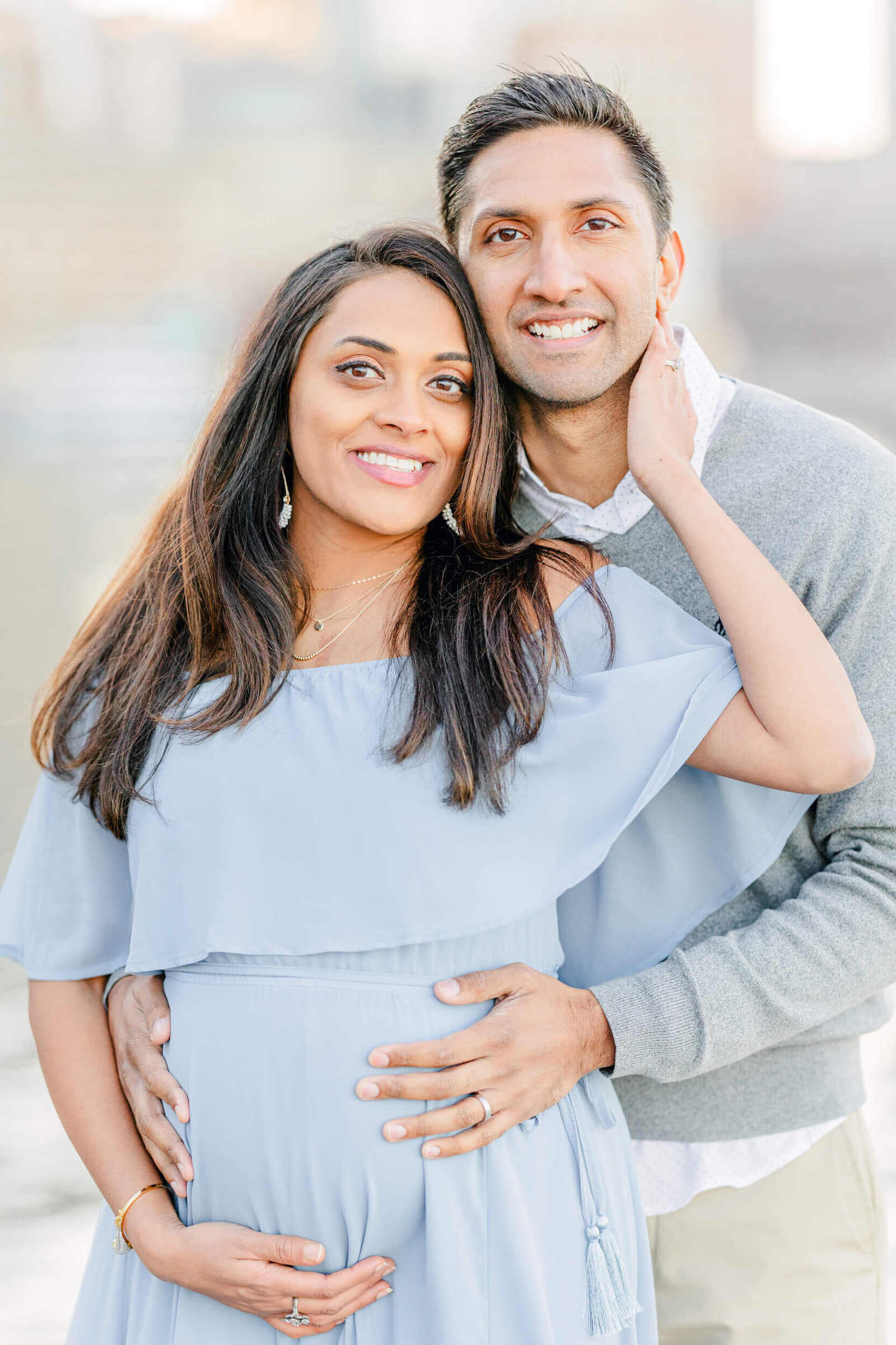 Pregnant woman and her husband smile