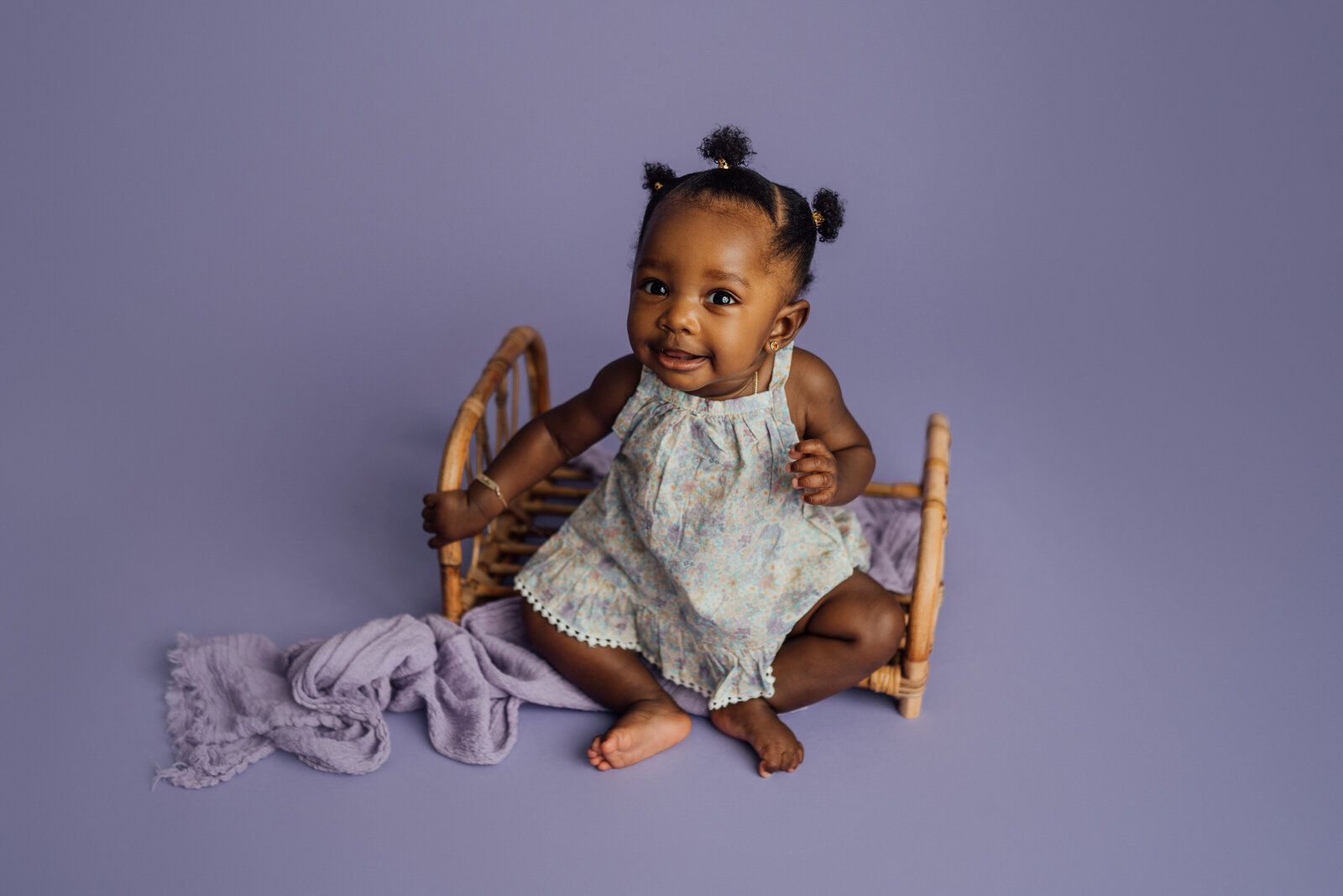 6 month old girl poses on bed prop during milestone session in St. Pete