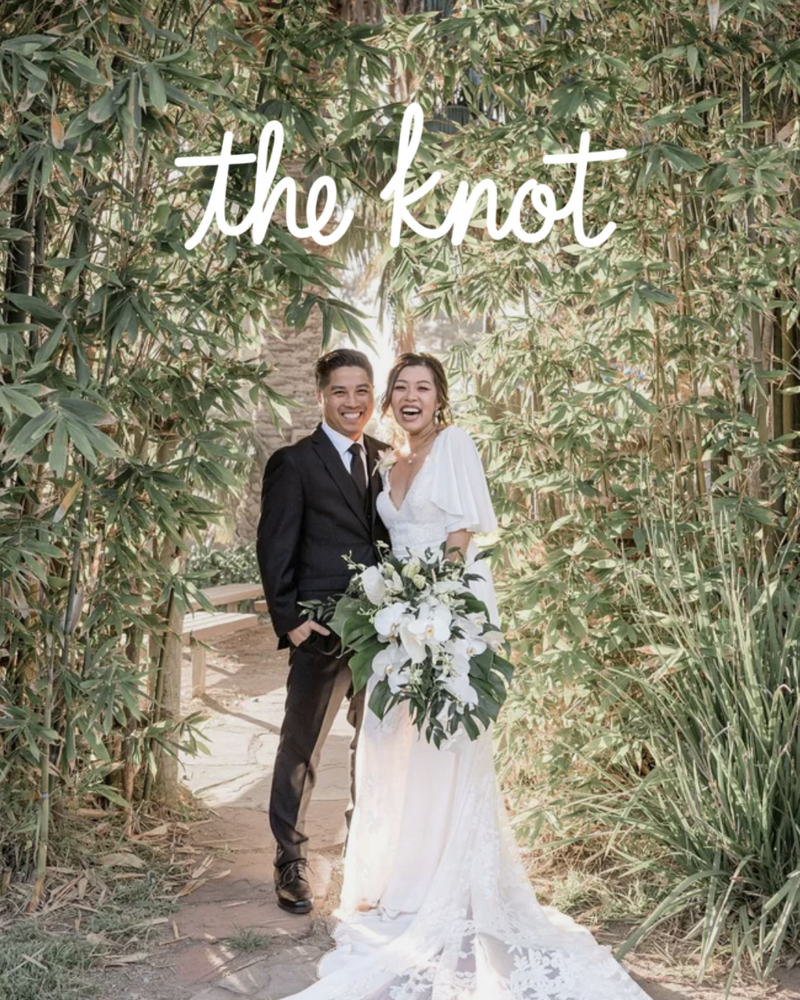 Kohnur bride with natural radiant makeup, pink lipstick, and loose waves in whimsical bamboo garden wedding editorial featured on The Knot
