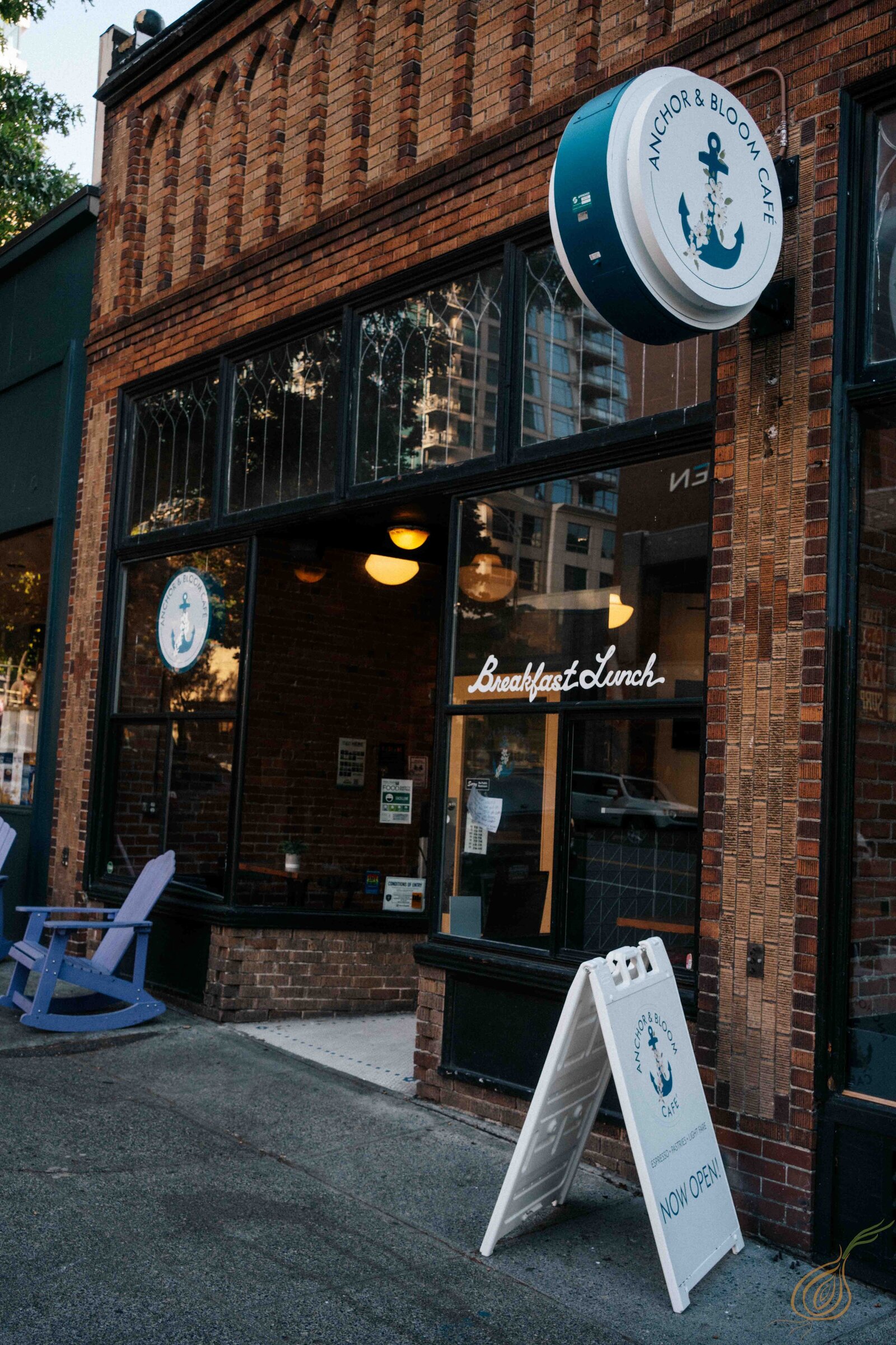 A stylish coffee shop sign located on the side of a building, designed to attract attention and invite patrons inside.