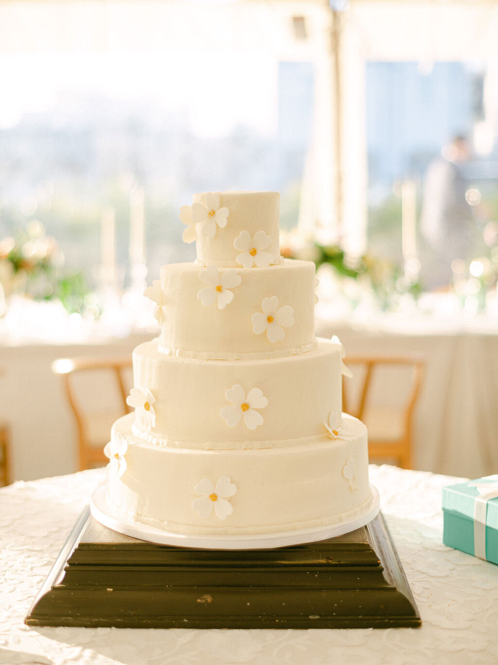 4 tiered wedding cake with white florals