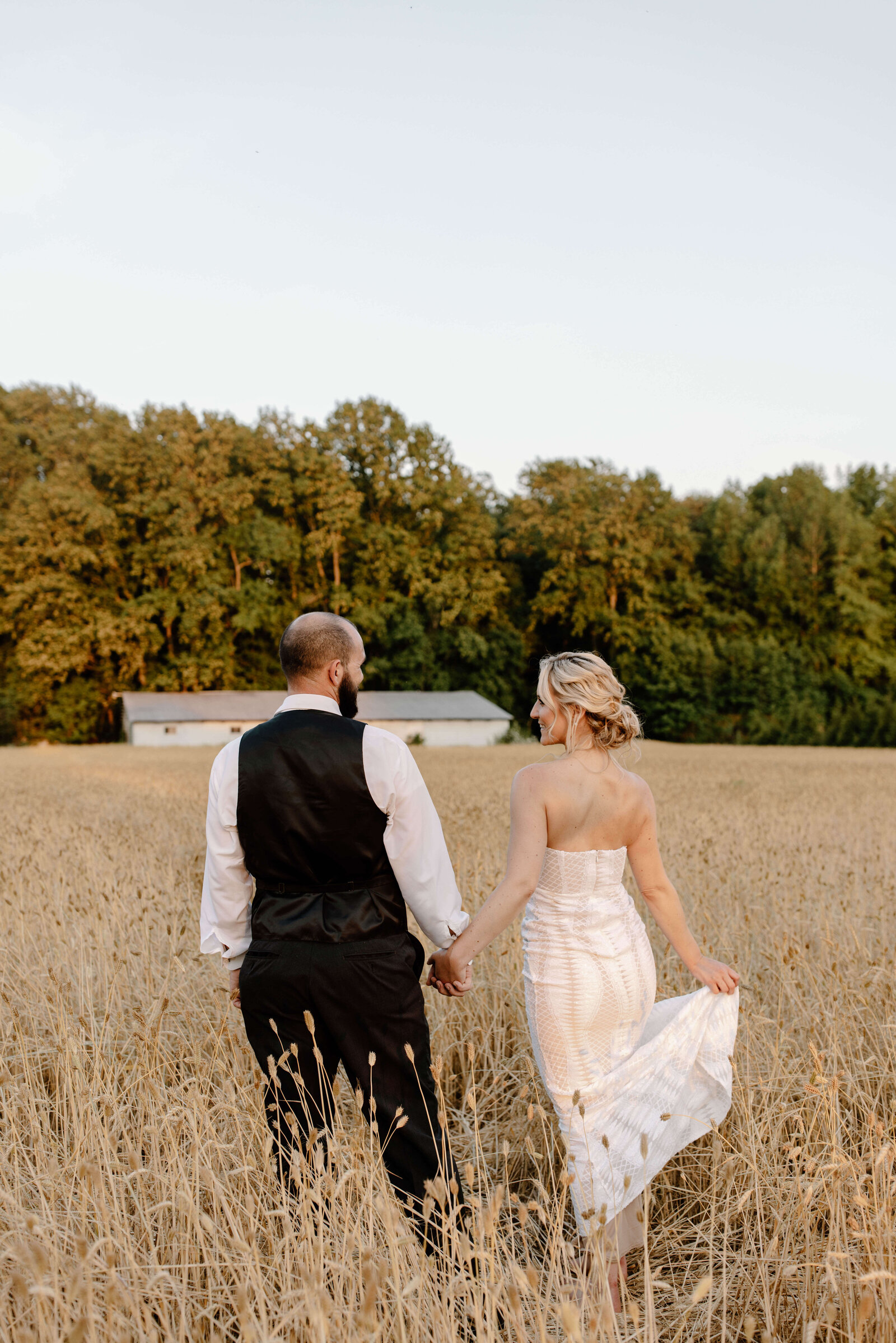 newlywed wedding portraits in grassy field at lavendar fields in milton delaware by sabrina leigh