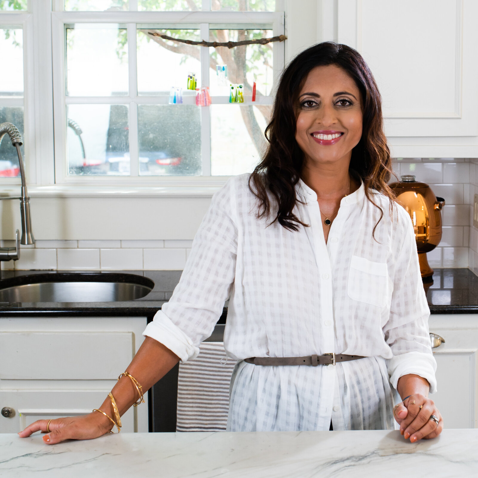 Woman in kitchen smiling at the camera