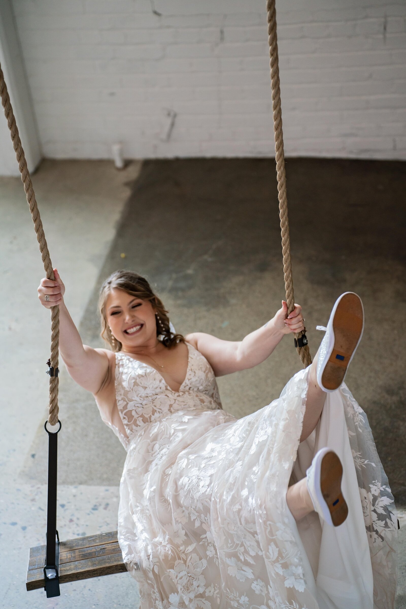 bride-fun-swinging-portrait-unique-venue-mn