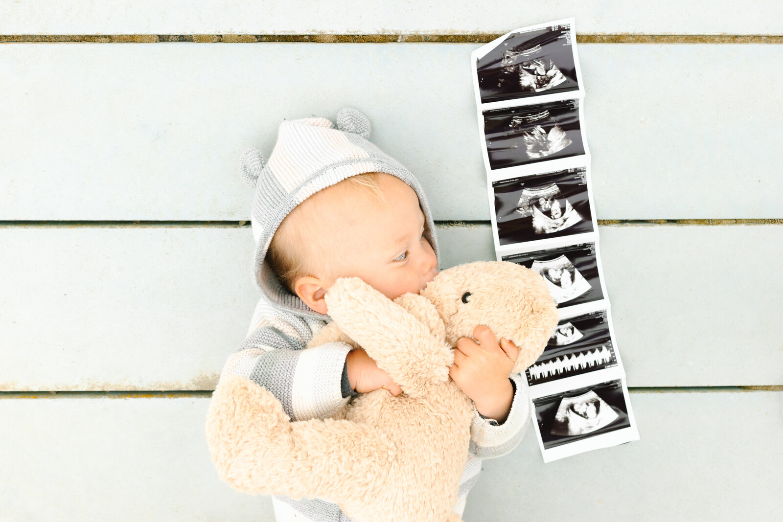 A toddler poses with his brother's sonogram in Los Angeles, Ca.