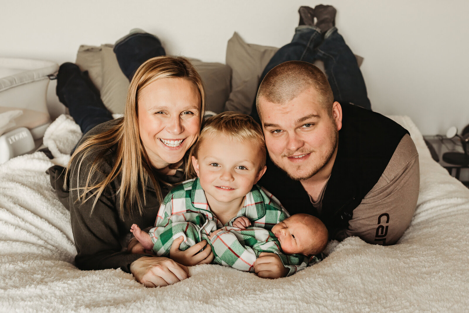 A family snuggles together during an in-home newborn session by Nikii Pix Photography in Walcott, ND.