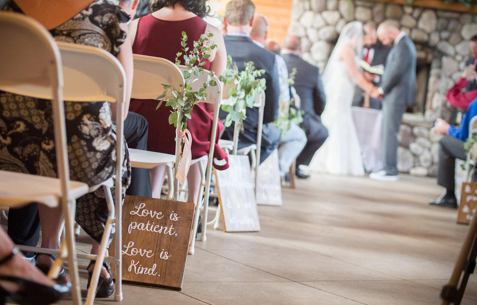 sign in focus with wedding ceremony in background