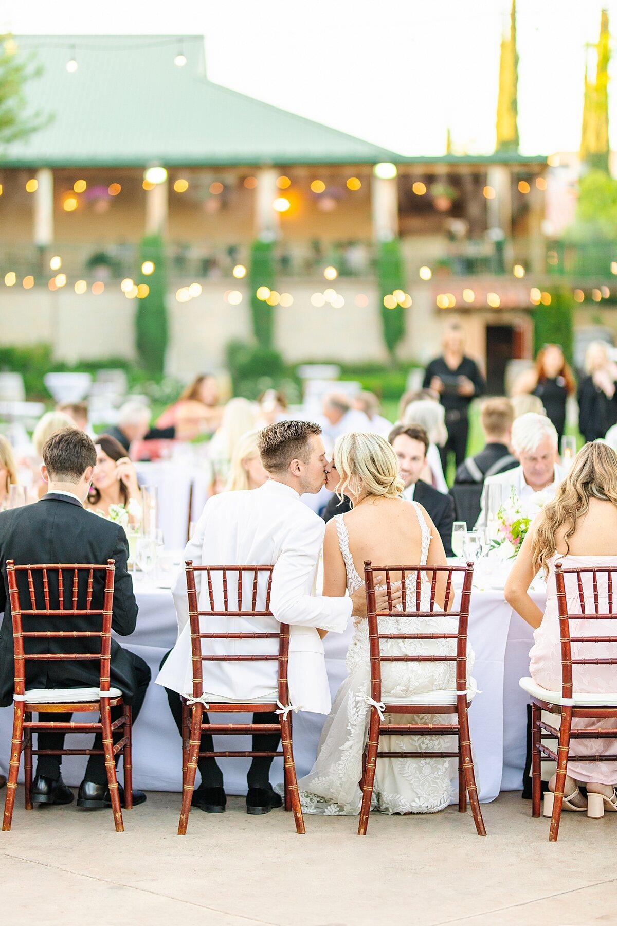 Bride and groom sharing a kiss during their wedding reception at South Coast Winery in Temecula, California.