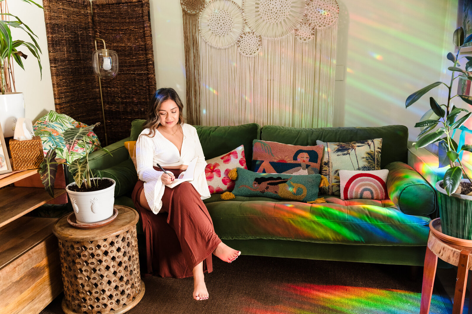 Coach for women writes in her journal , sit in a green couch