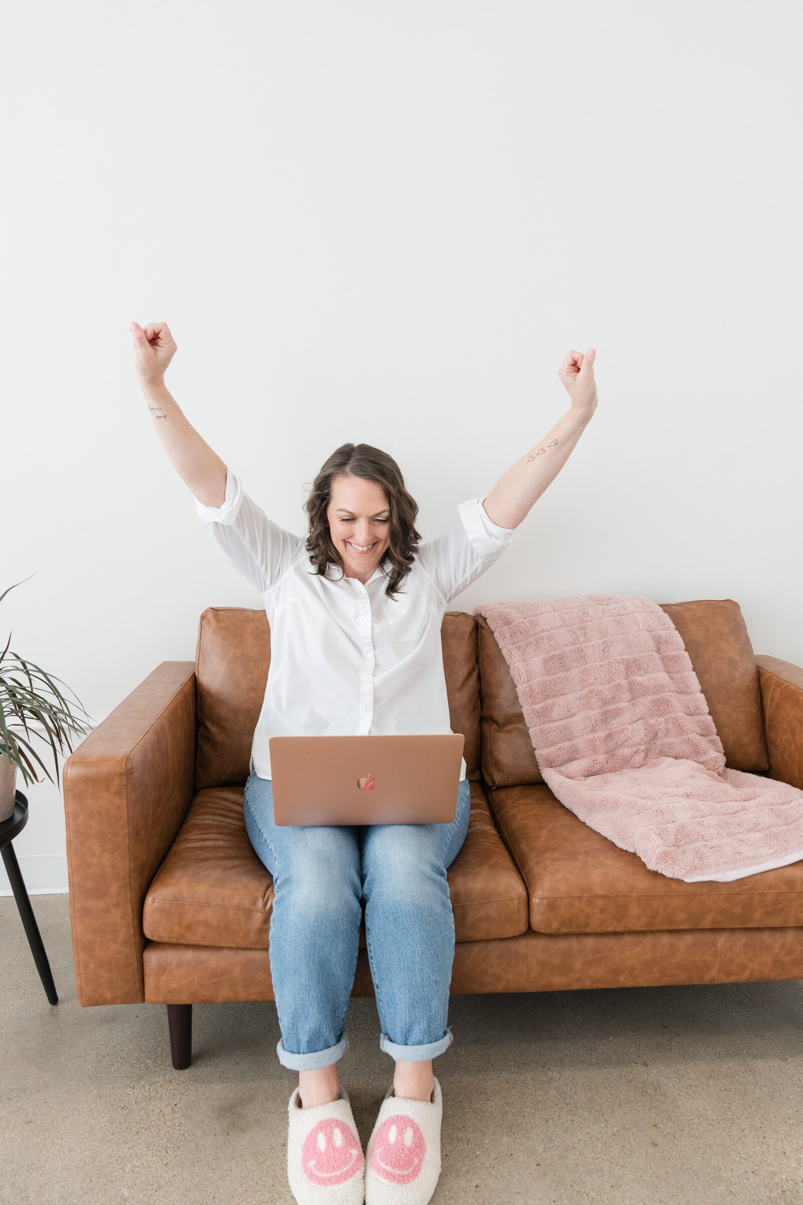Hands in the air with laptop in lap