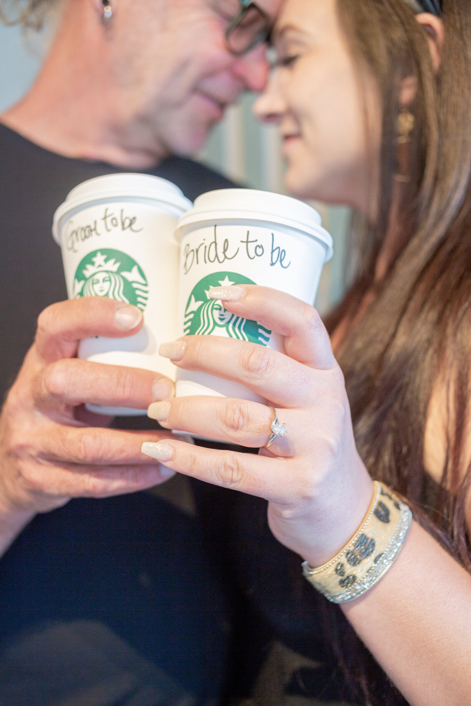 Seattle Wedding Photographer captures couple with foreheads together holding Starbucks coffee cups
