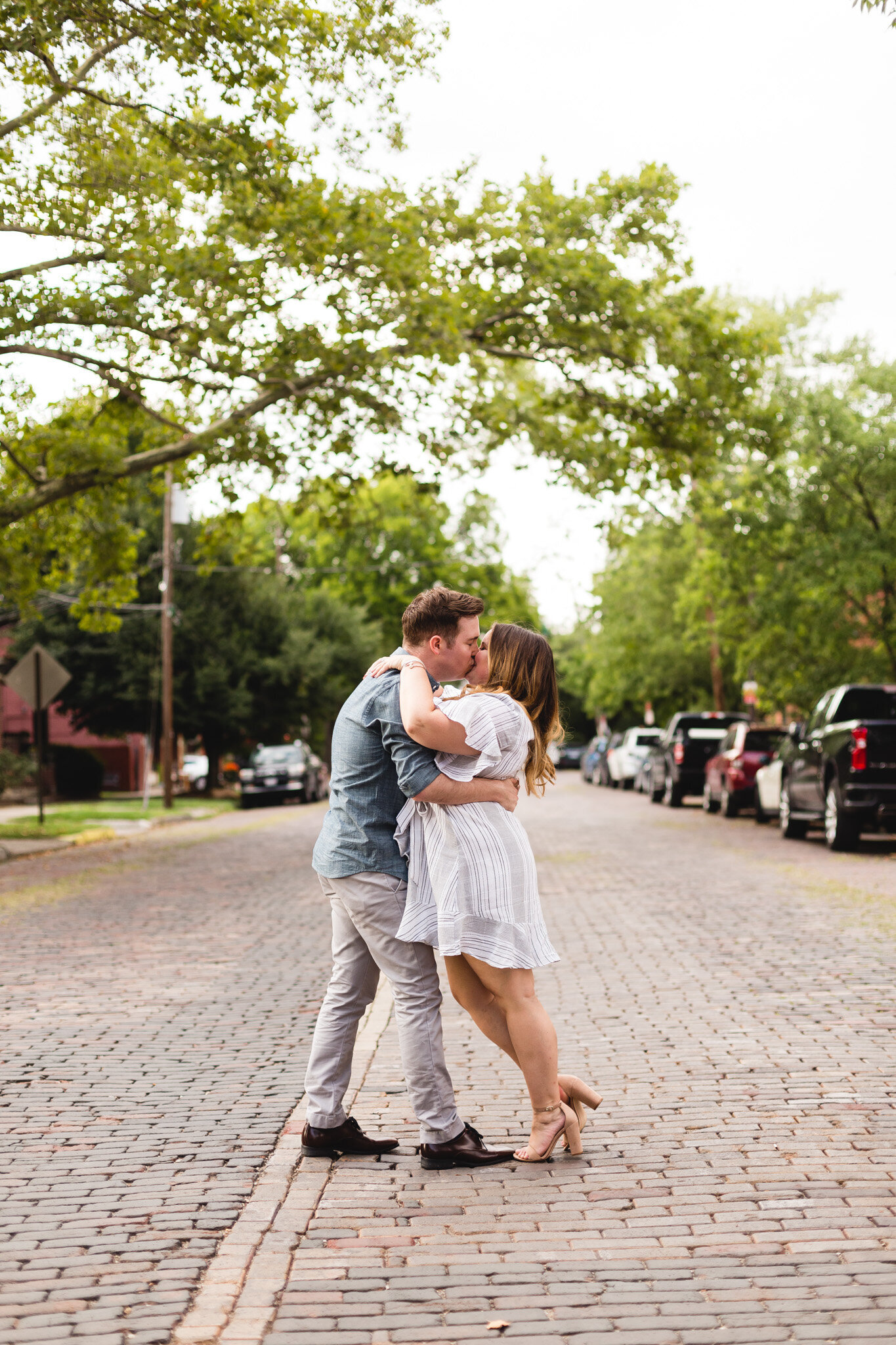 engaged couple kissing in brick road german village ohio photographer