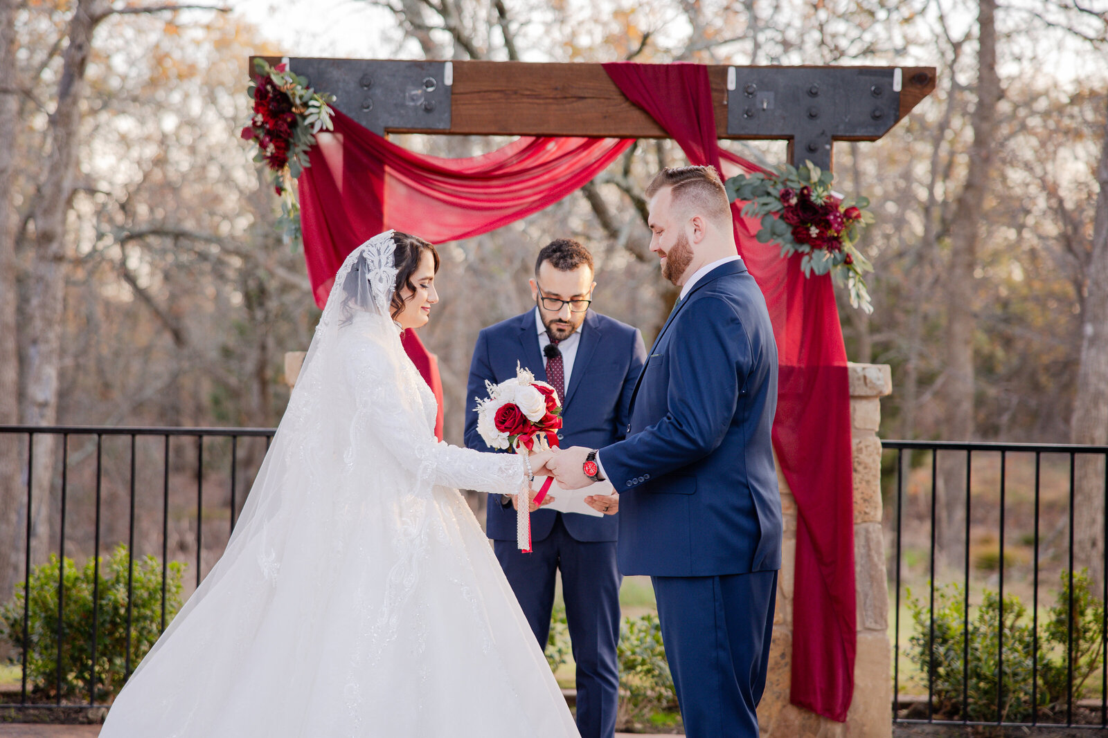 Outdoor ceremony surrounded by nature, featuring raw and candid moments as the couple says ‘I do.’