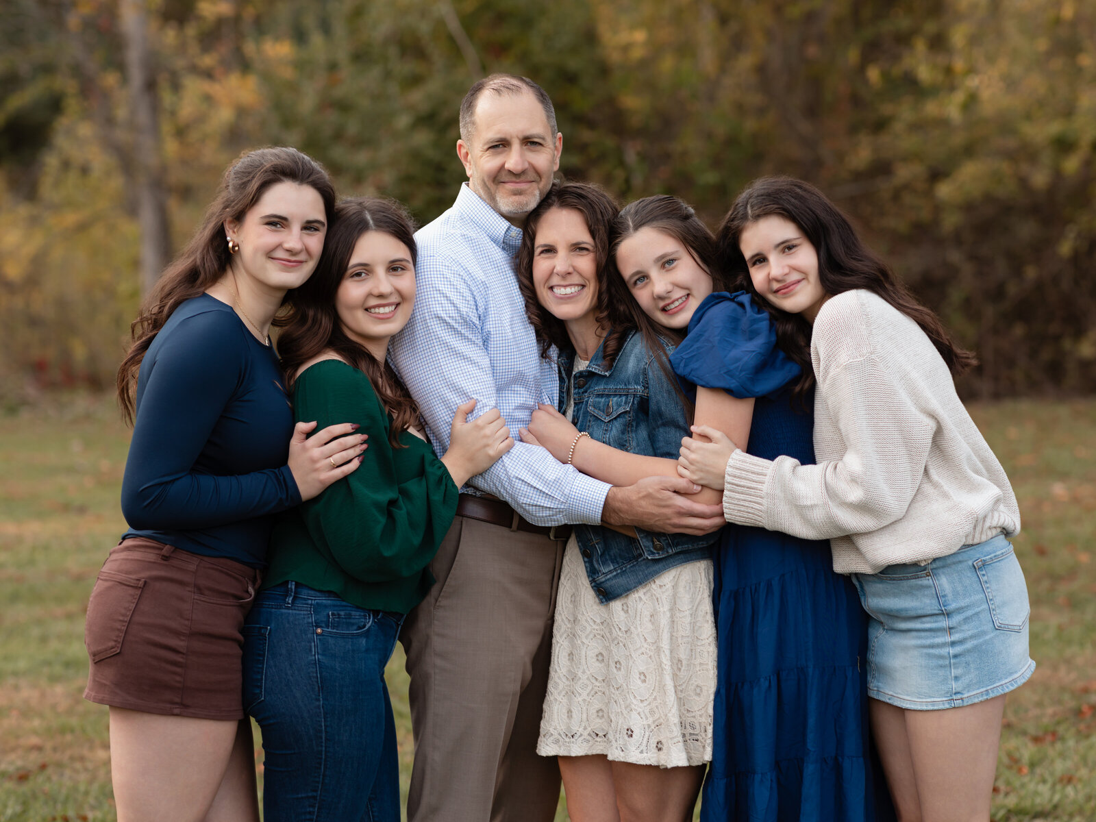 parents and four daughters hugging for family photos Cleveland family photography