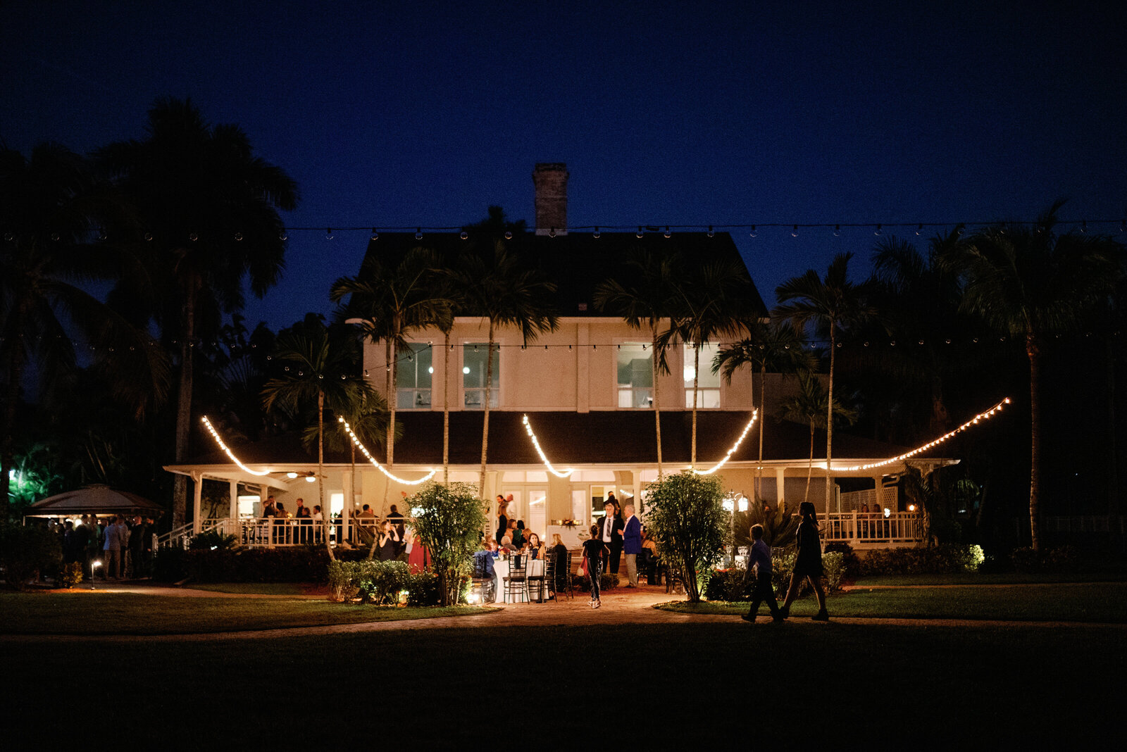 wide view of White Orchid at Oasis at night during wedding reception. String lights are lit