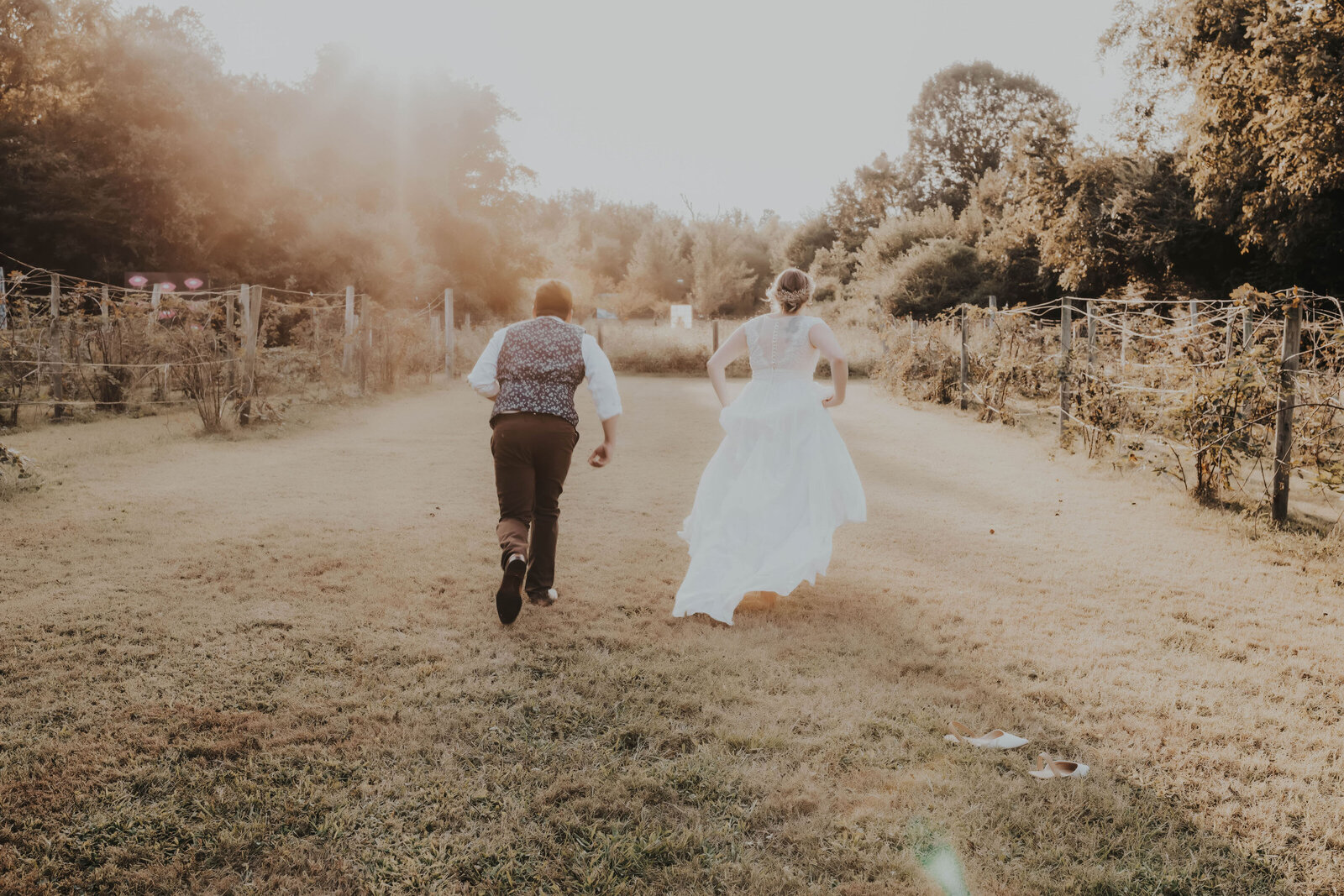 newlyweds running at a farm