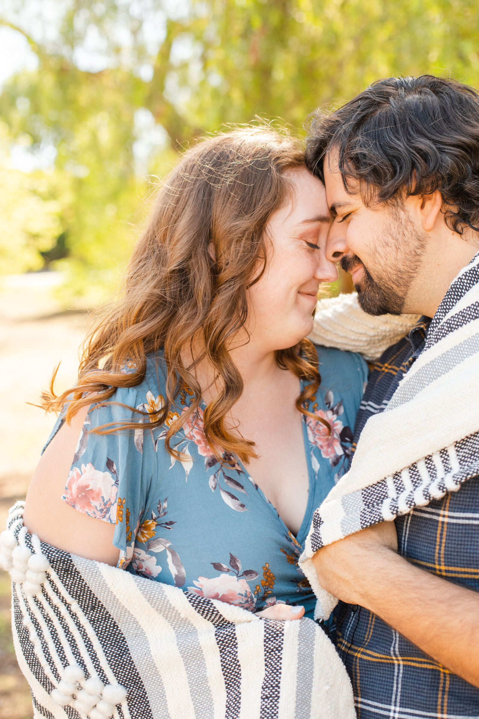 An engaged couple poses for photos in a garden in Los Angeles, Ca.