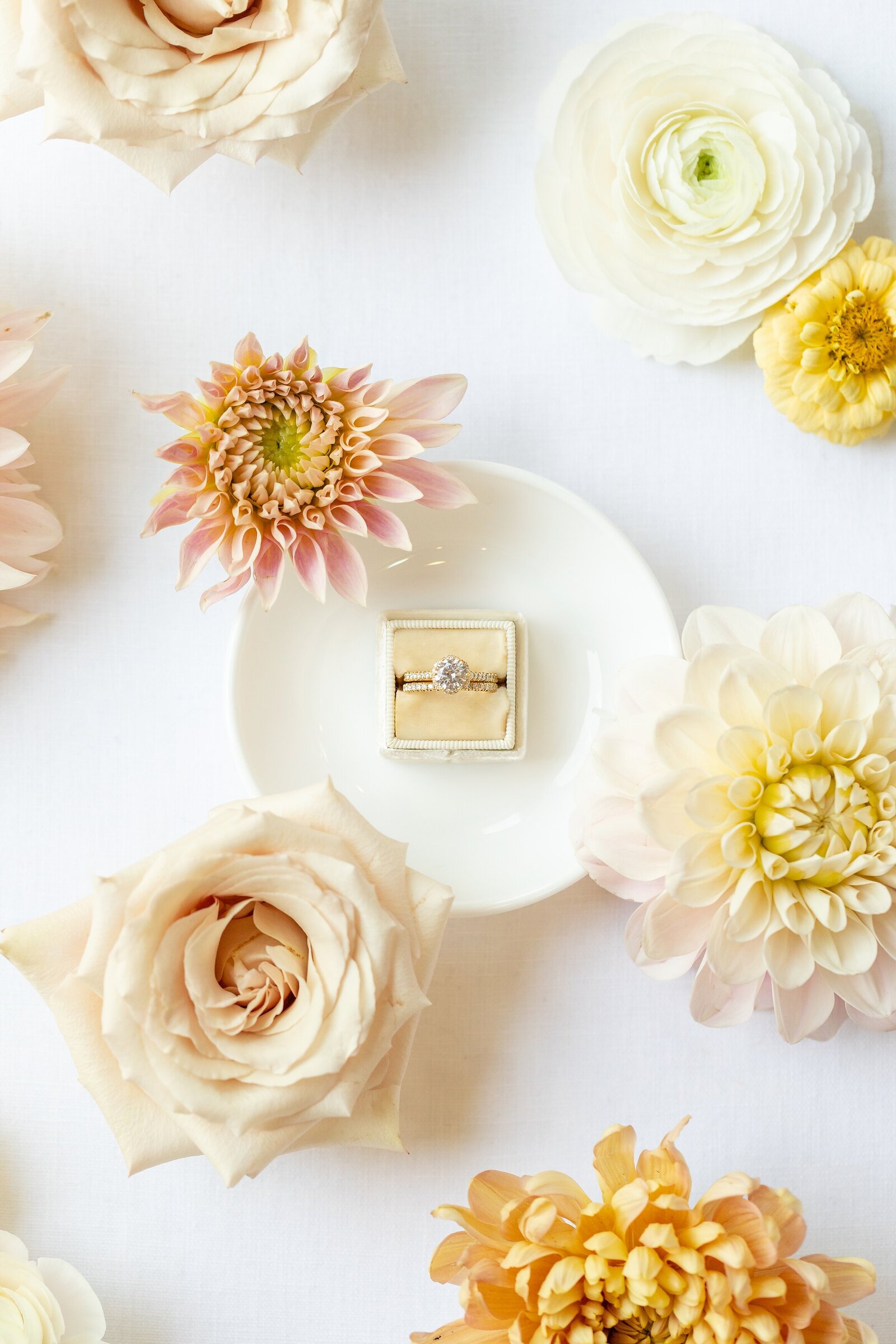 Wedding-ring-surrounded-by-soft-colourful-florals