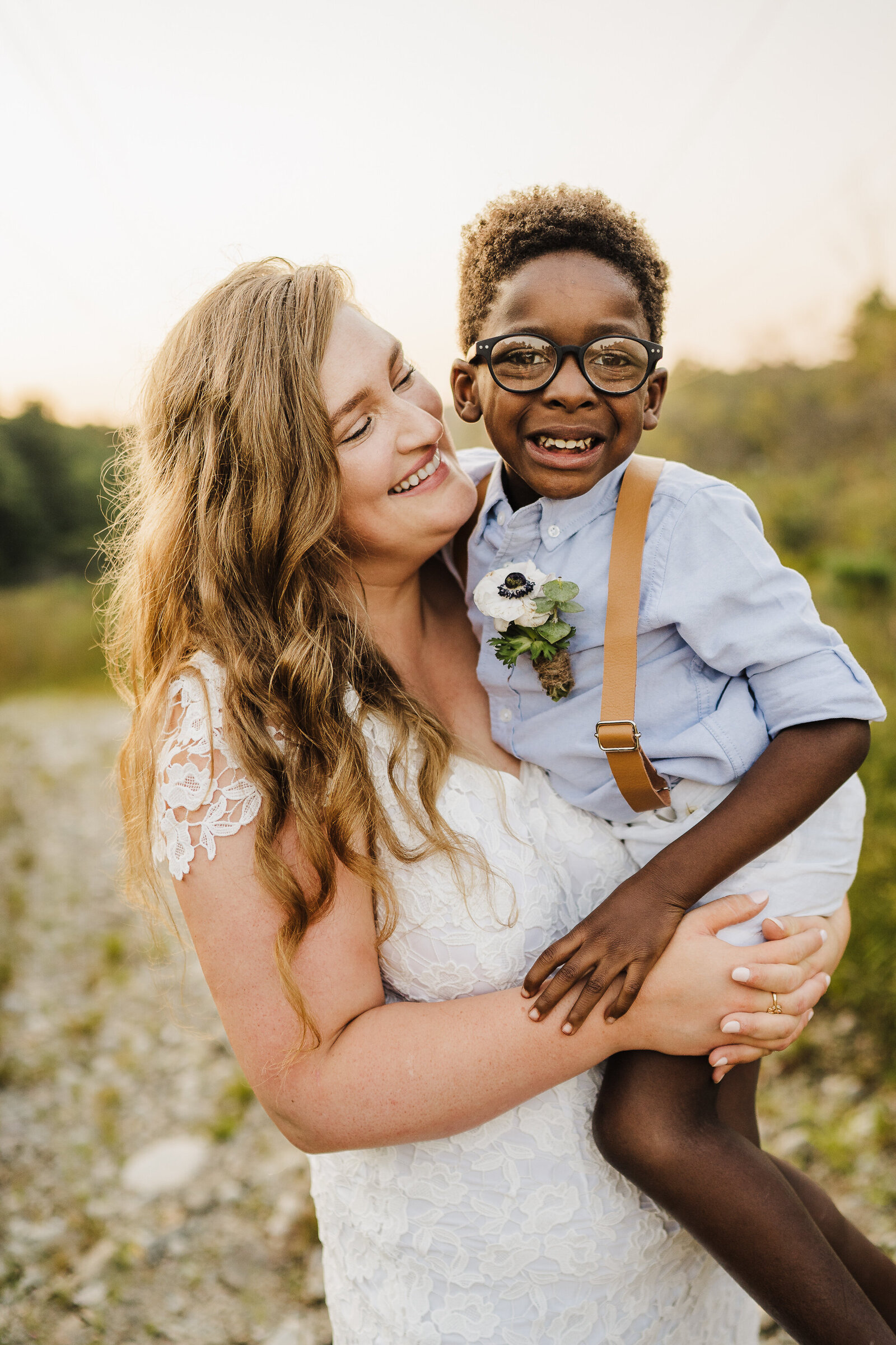 bride holding son after wedding ceremony
