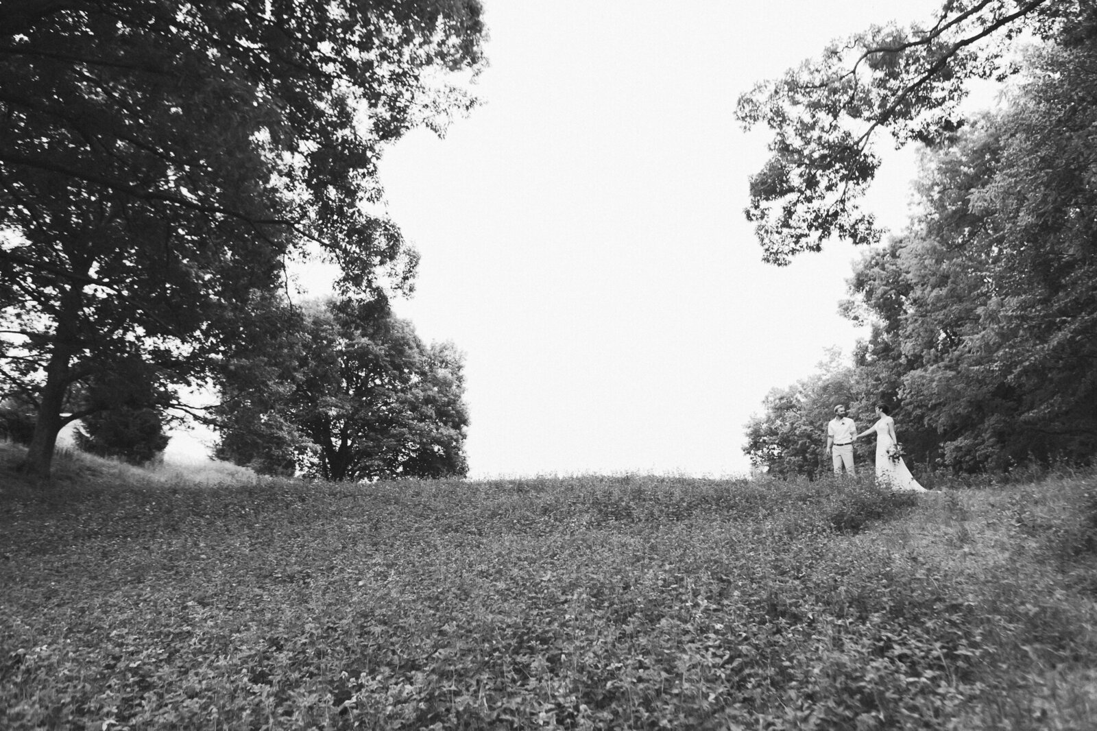 Bride and Groom walking on a path at re farm cafe