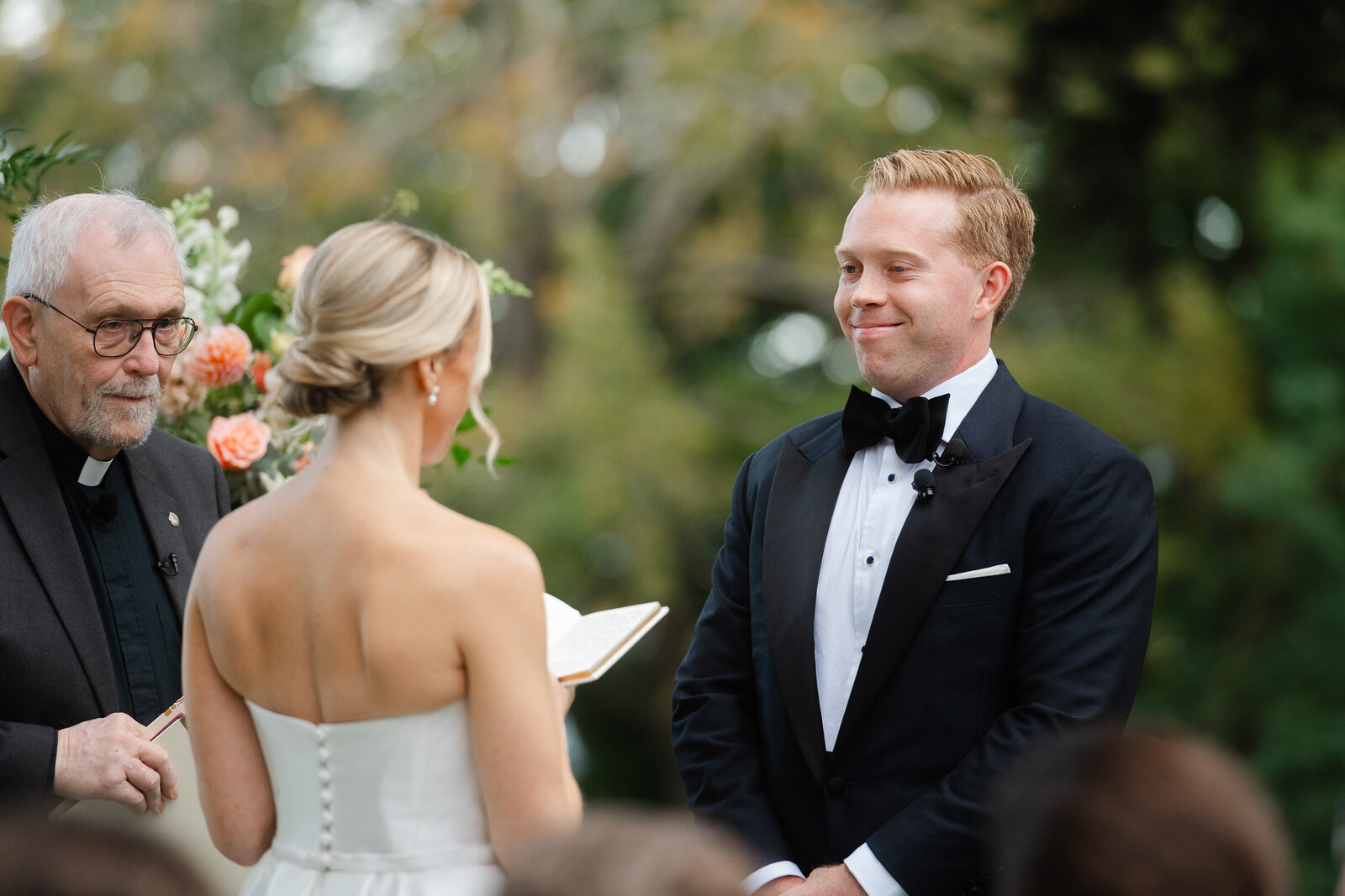 groom smiling at head of aisle