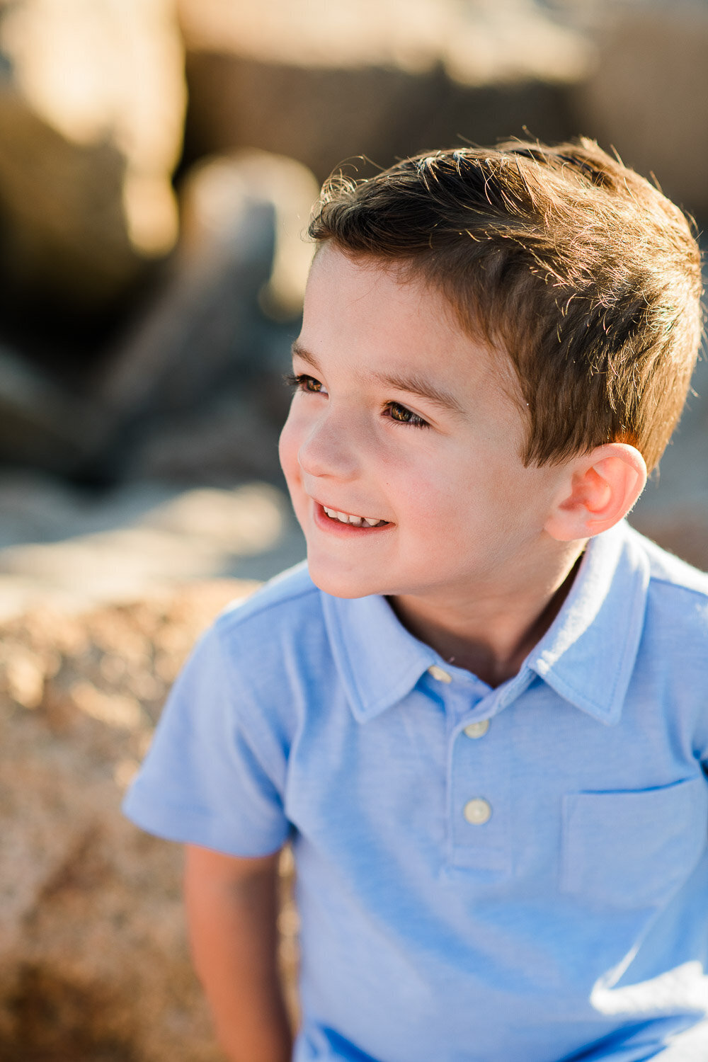 young boy in sunlight at beach