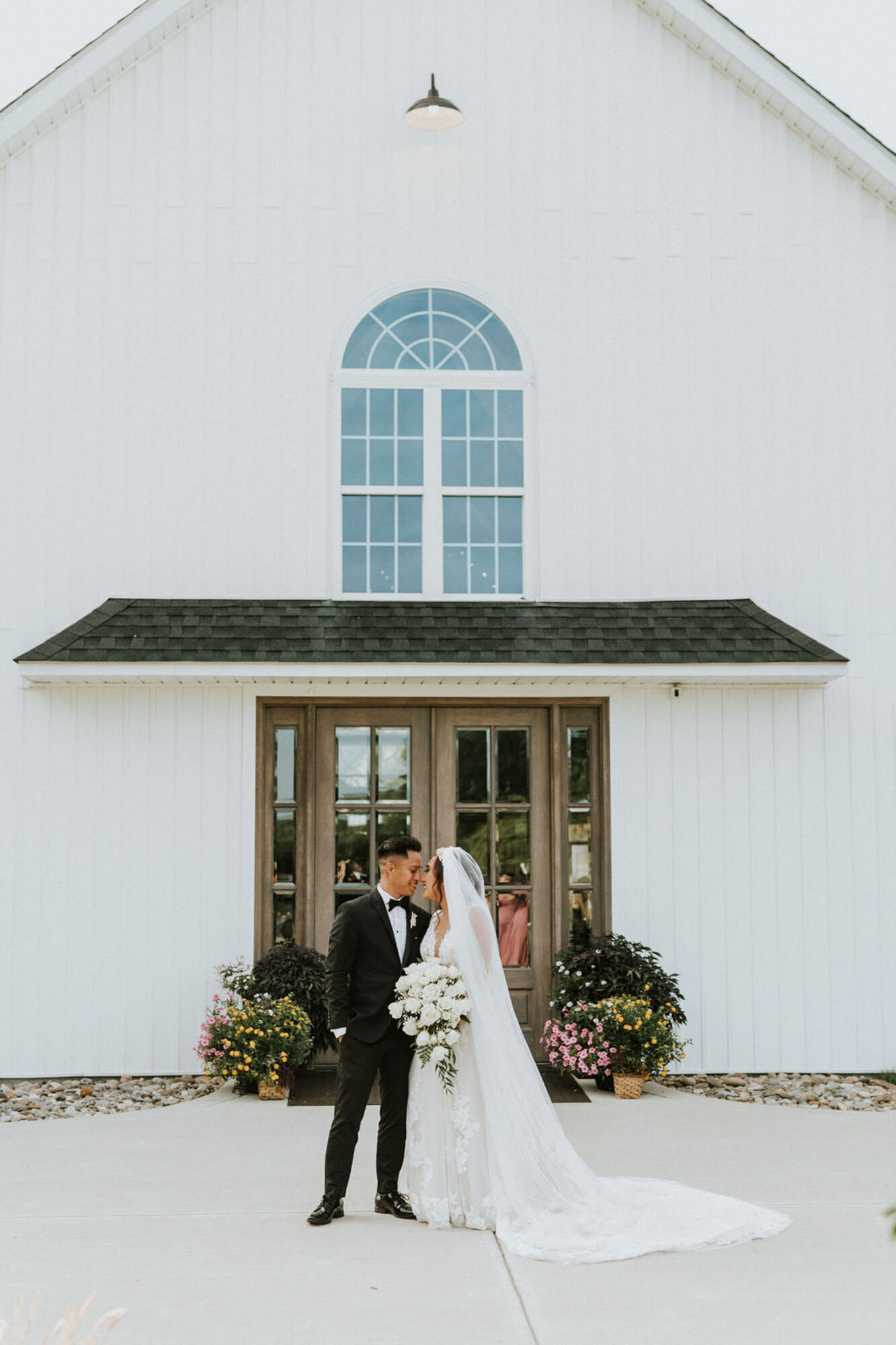Bride and groom in front of venue at North Carolina destination wedding