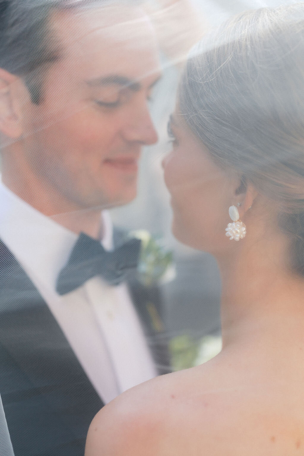 Groom and bride about to kiss under veil at Summerour Studio