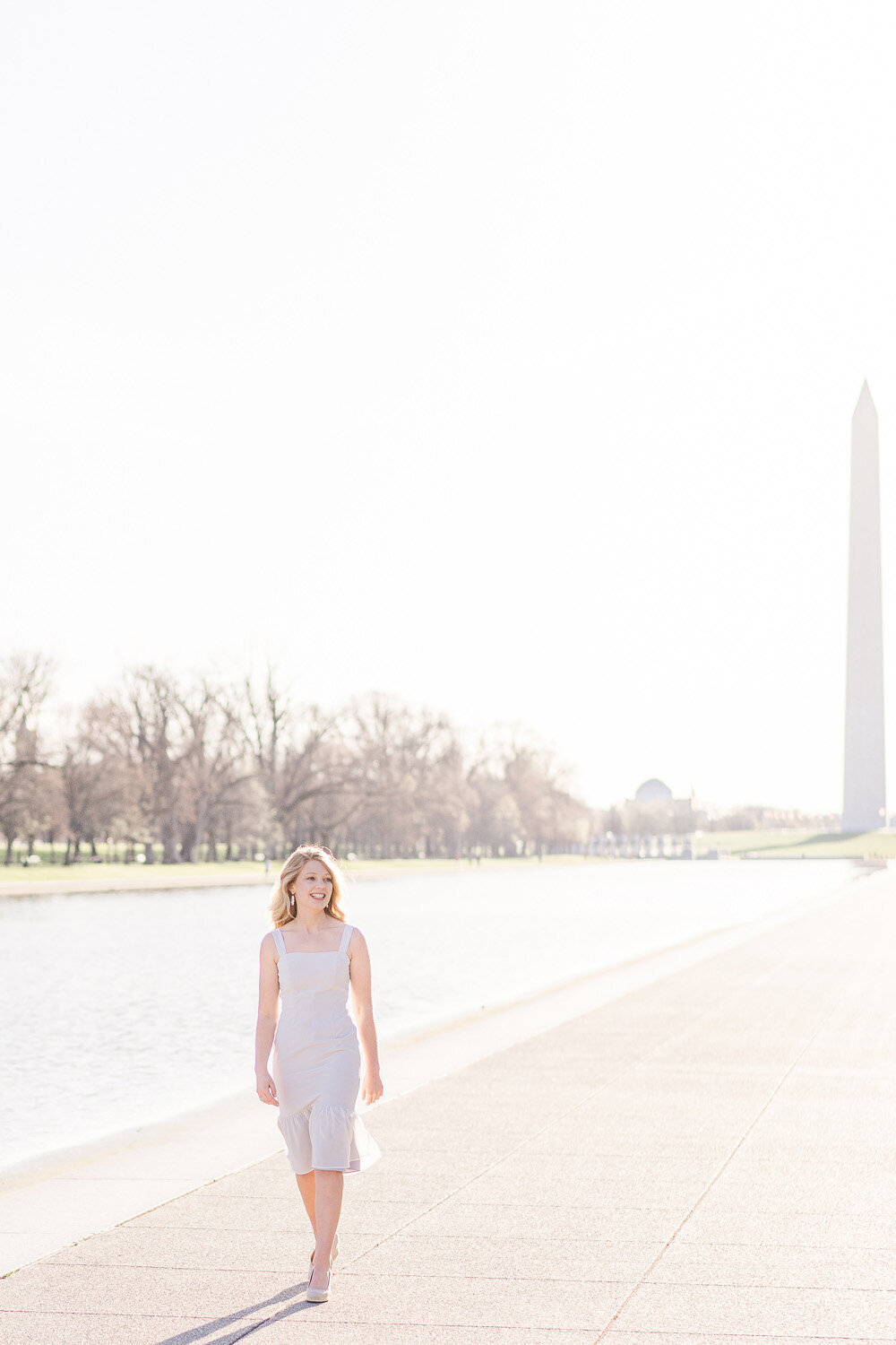 college girl walking next to the reflecting pool during Washington, DC senior photo