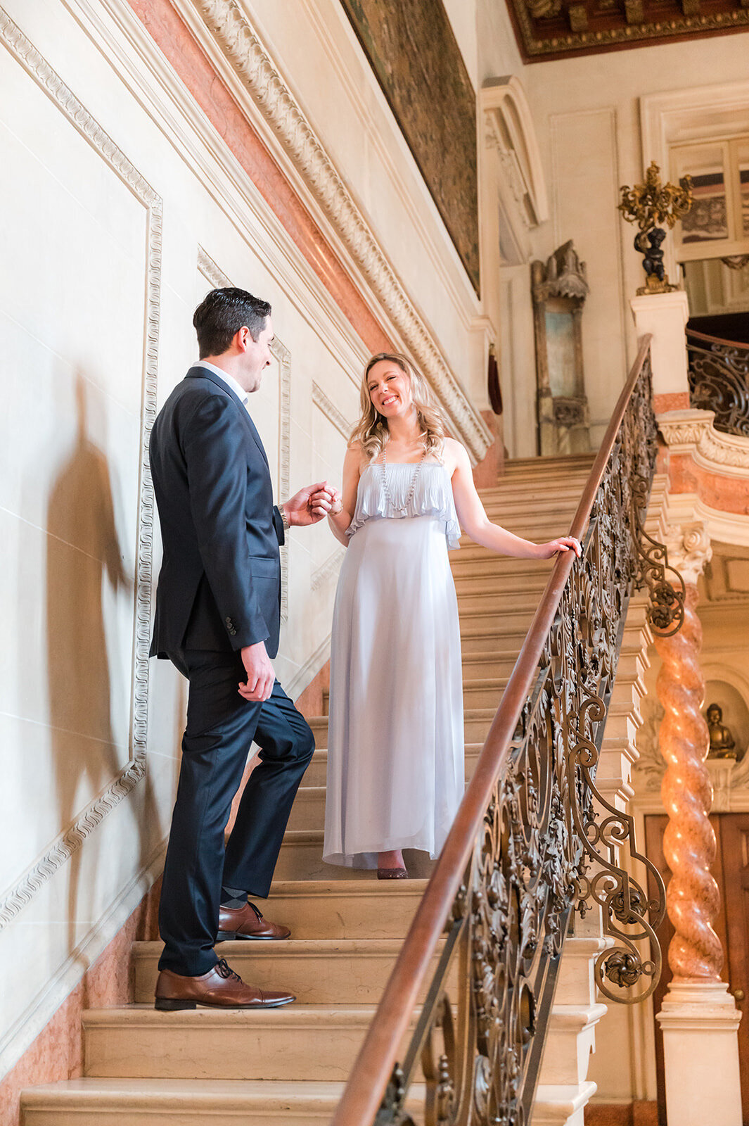 Engaged couple on grand staircase at Larz Anderson House in Washington DC