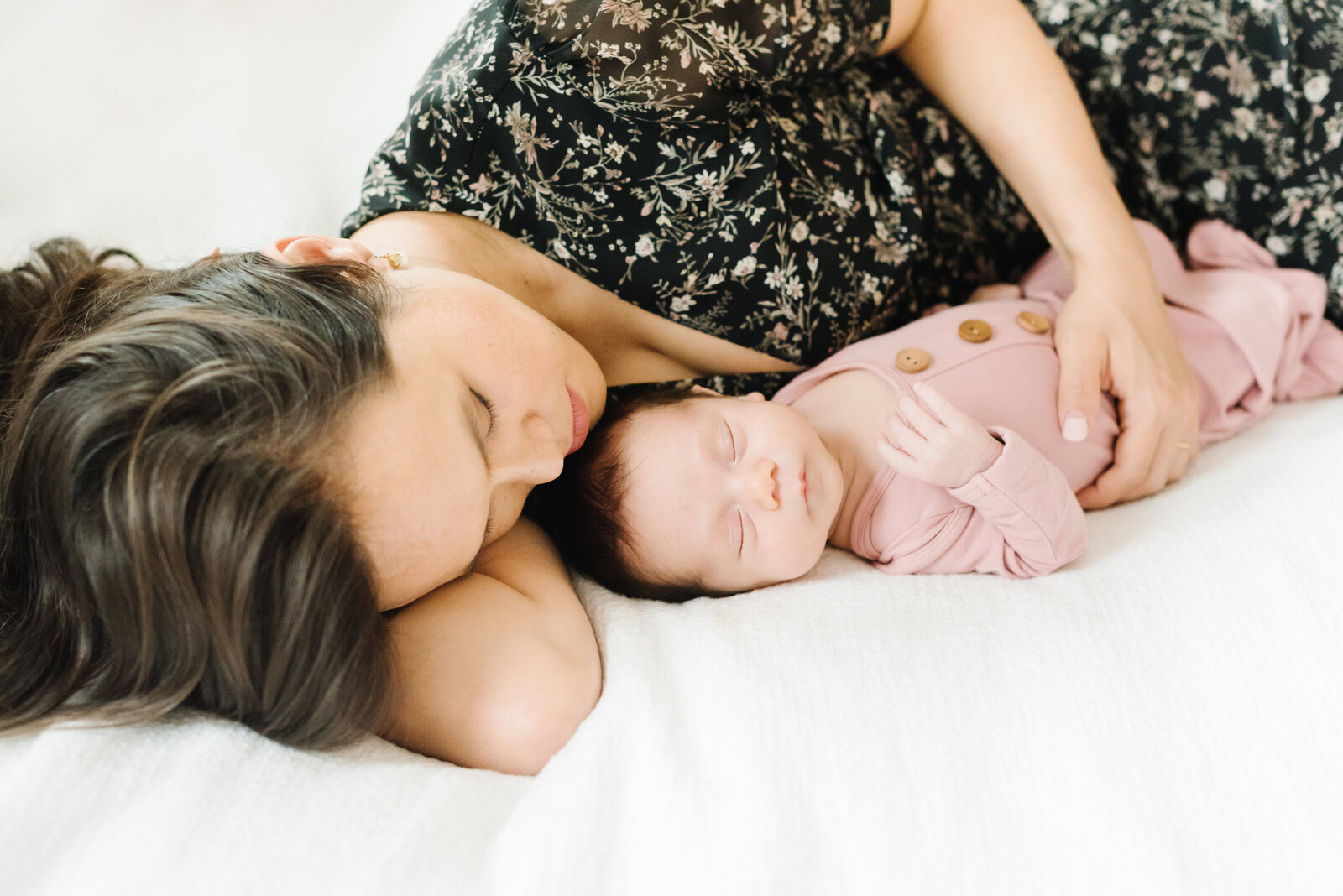 Mom lying down with hand on sleeping infant - DC Newborn Photographer