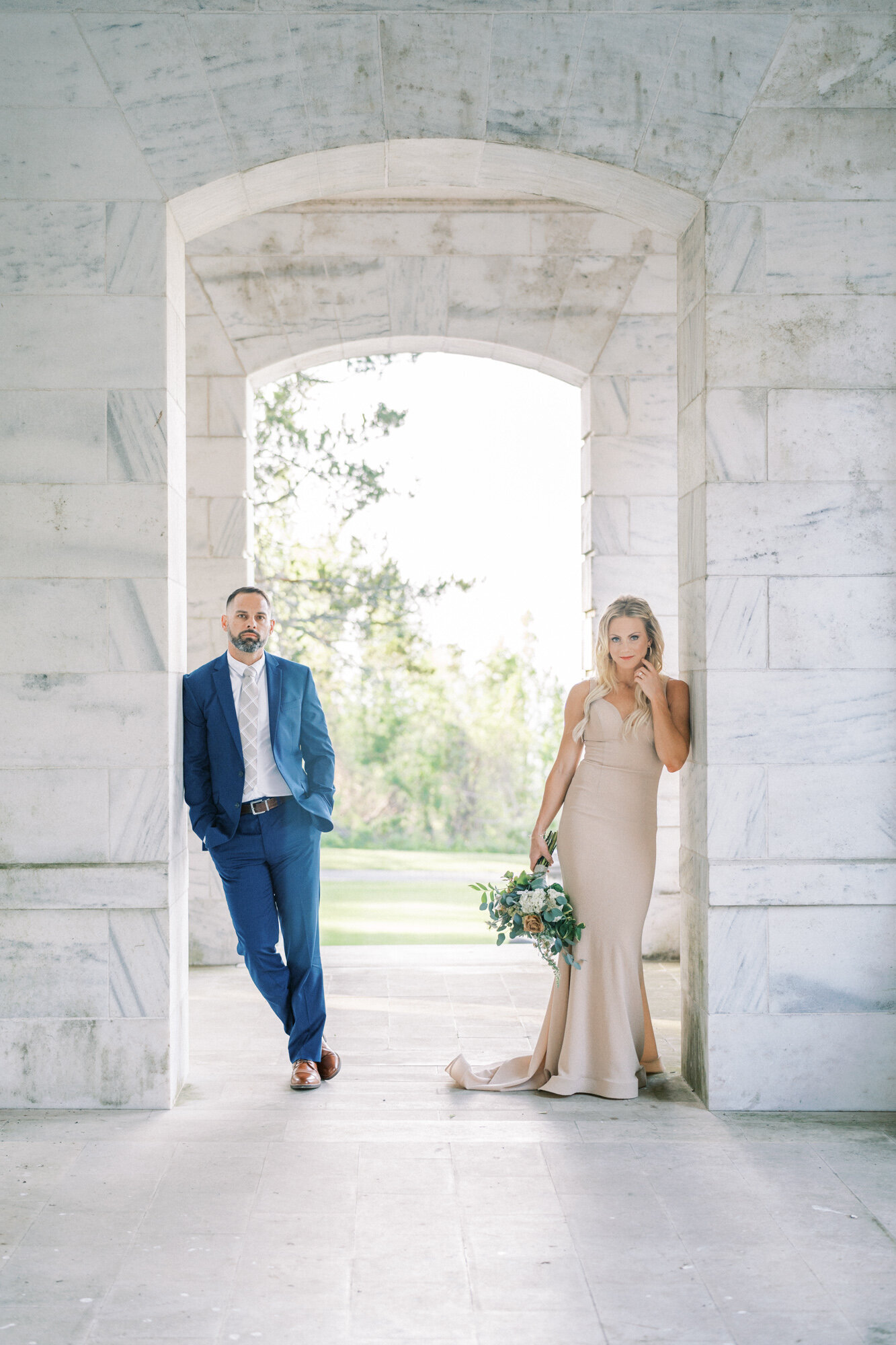 Bride and groom lean on a marble wall at a DC venue