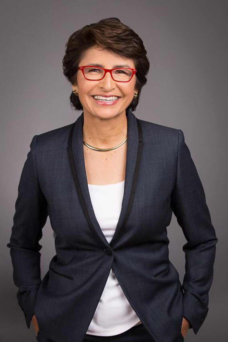 Corporate headshot of woman in red glasses in Austin TX