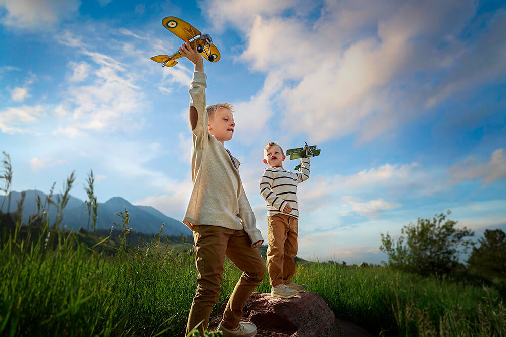boys-blond-playing-with-airplanes-imagination-colorado-mountain-view-boulder-timeless-creative-unique-wall-art-childhood-big-colorado-sky-clouds