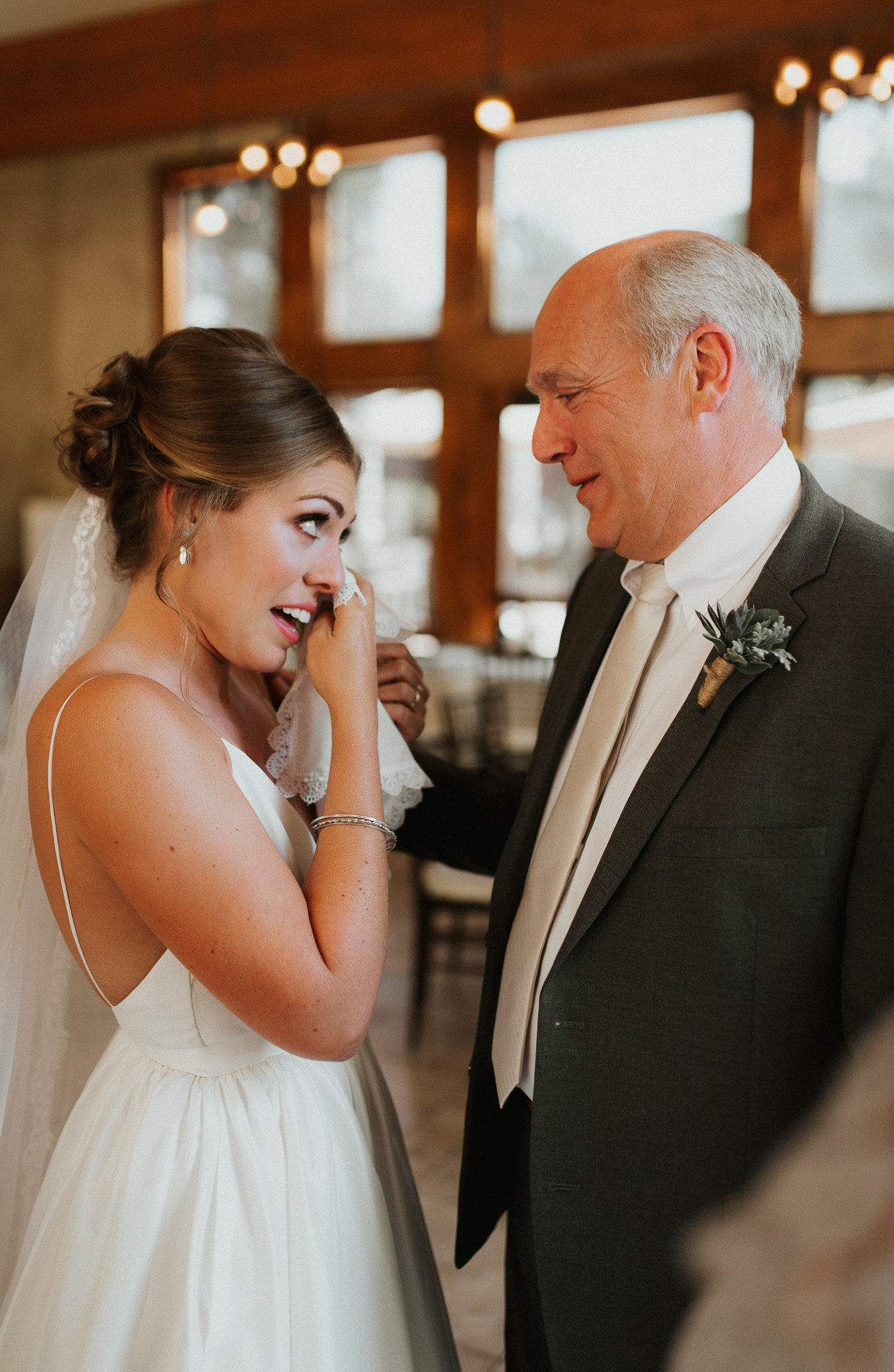 Bride crying with her dad at wedding in Denver