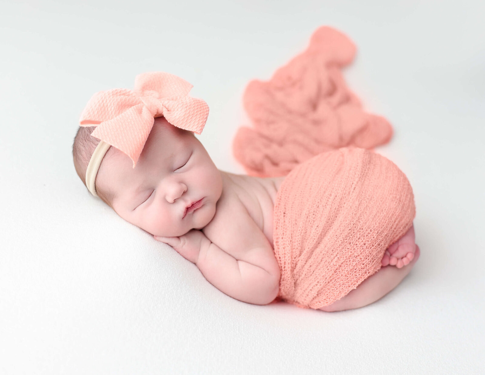 Newborn girl posed at our Rochester, Ny studio.